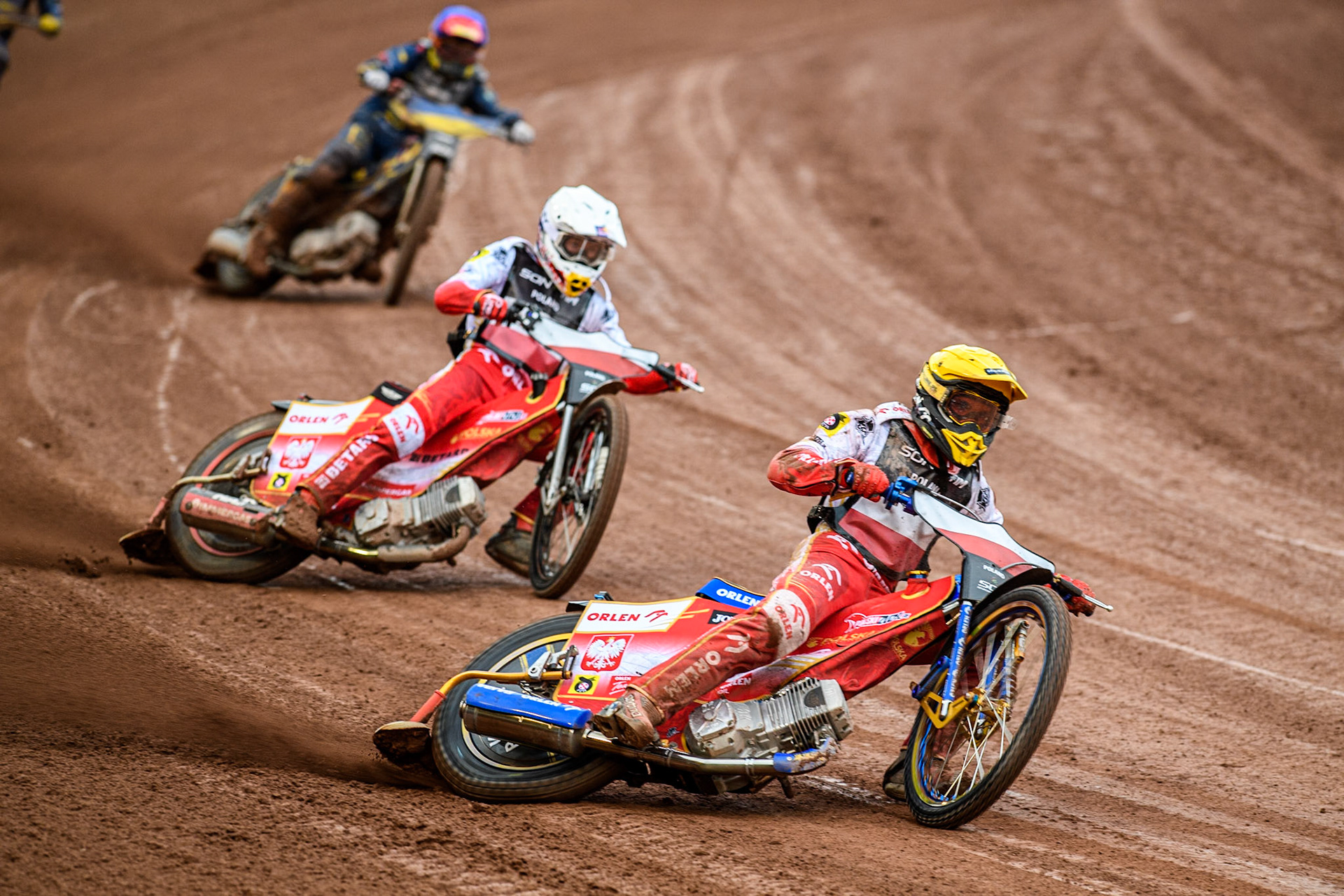 Ukraine v Poland: Bartosz Zmarzlik of Poland in Yellow leading Dominik Kubera of Poland in White with Marko Levishyn of Ukraine in Blue behind during the Monster Energy FIM Speedway of Nations Semi-Final 1 at the National Speedway Stadium, Manchester on Tuesday 9th July 2024. (Photo: Ian Charles | MI News)