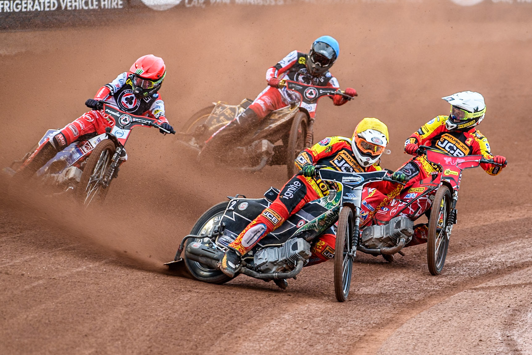 Leicester Lions' Richard Lawson in Yellow leading team mate Leicester Lions' Max Fricke in White, Belle Vue Aces' Dan Bewley in Red and Belle Vue Aces' Norick Blodorn in Blue during the Rowe Motor Oil Premiership match between Belle Vue Aces and Leicester Lions at the National Speedway Stadium, Manchester on Monday 24th June 2024. (Photo: Ian Charles | MI News)