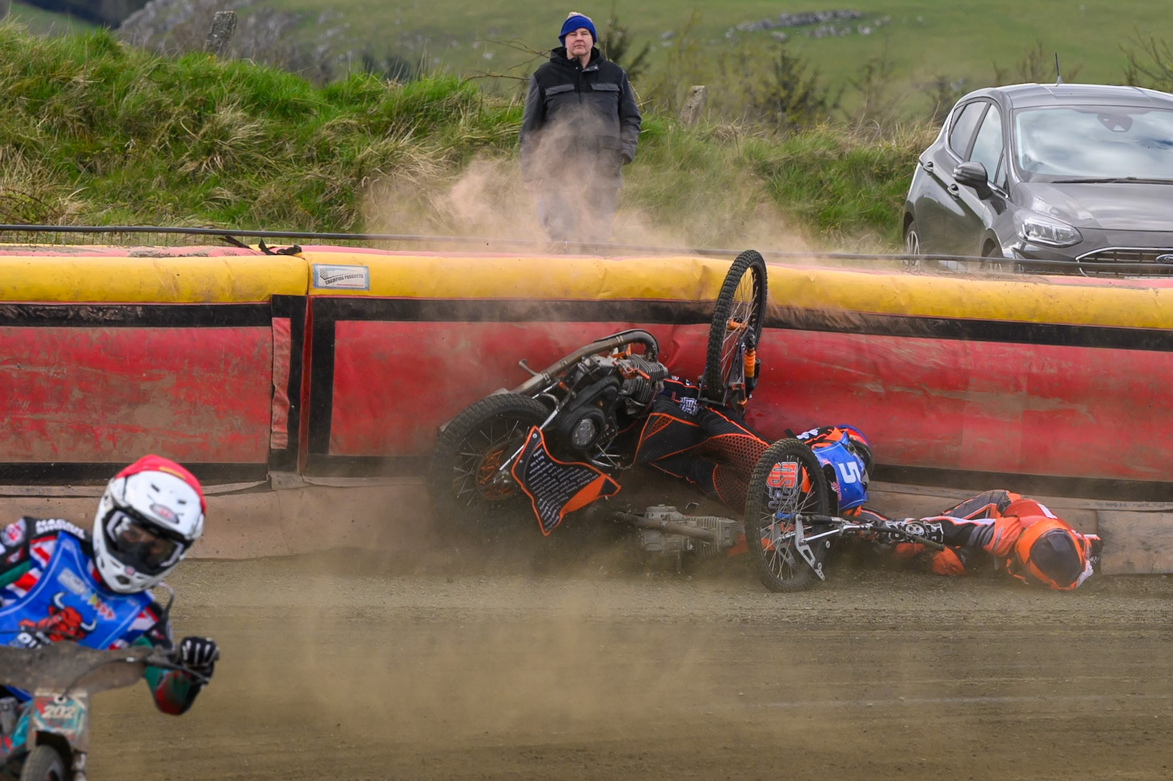 Connor Coles of NDL Nomads   in White fall and Jack Smith of Buxton Bulls   in Blue collides with him during the  Challenge match between Buxton Bulls and NDL Nomads at Hi-Edge Speedway, Buxton on Sunday 19th April 2026. (Photo: Ian Charles | MI News)