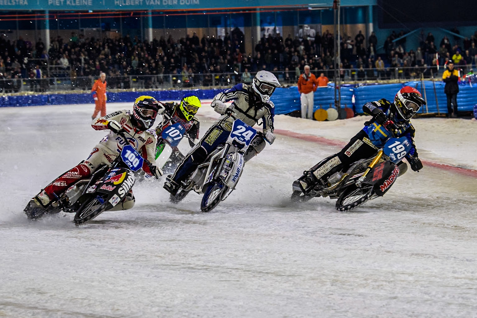 Sweden's Martin Haarahiltunen (199)  in Red rides inside Finland's Max Koivula (24) and Austria's Franz Zorn (100) in Yellow with Germany's Markus Jell (82) in White behind  during the FIM Ice Speedway Gladiators World Championship Final 4 at Ice Rink Thialf, Heerenveen on Sunday 7th April 2024. (Photo: Ian Charles | MI News)