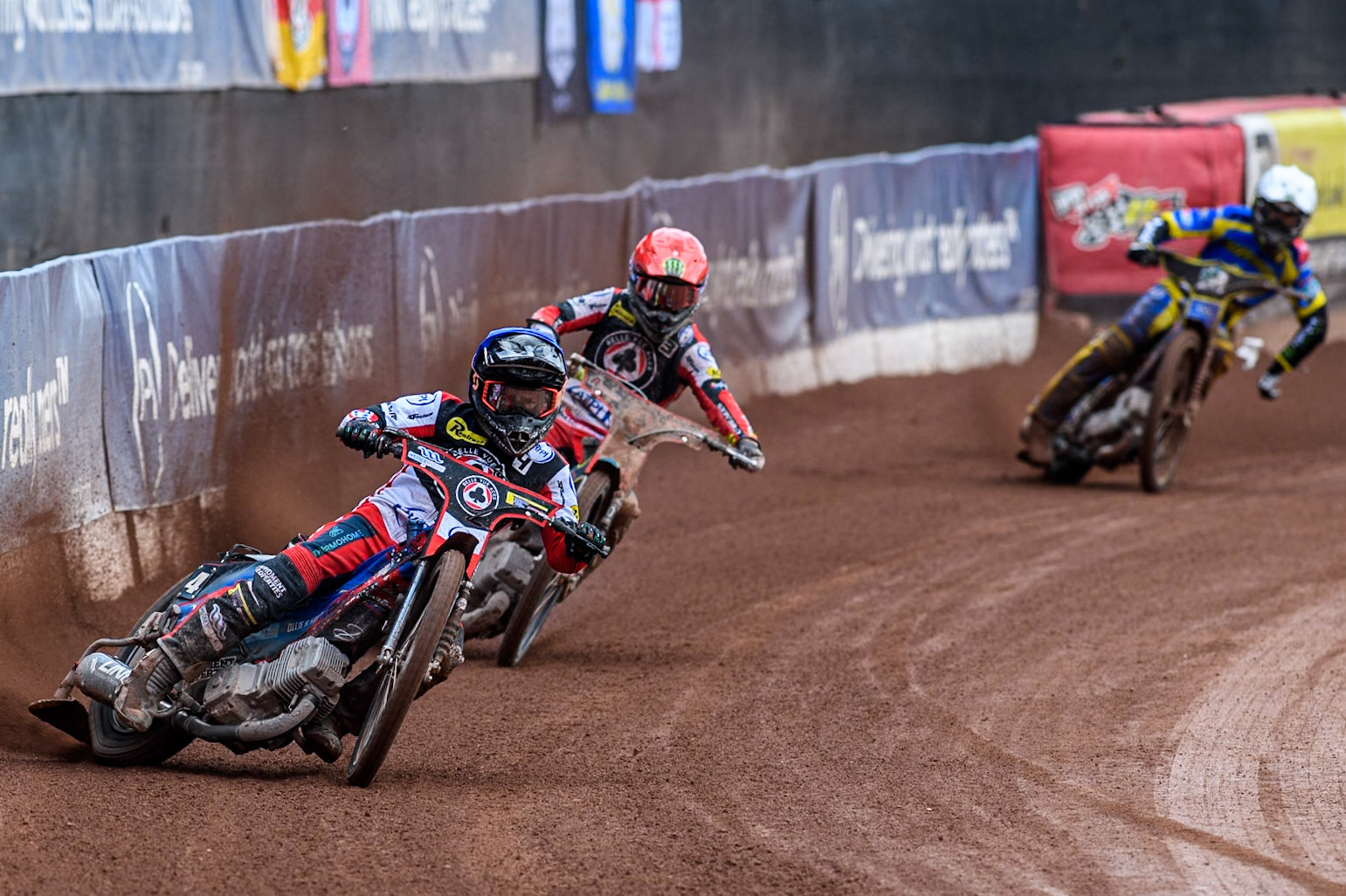 Belle Vue Aces' Ben Cook  in Blue and Belle Vue Aces' Jaimon Lidsey  in Red leading Sheffield Tigers' Jack Holder  in White and Sheffield Tigers' Kyle Howarth  in Yellow during the Rowe Motor Oil Premiership match between Belle Vue Aces and Sheffield Tigers at the National Speedway Stadium, Manchester on Monday 26th August 2024. (Photo: Ian Charles | MI News)