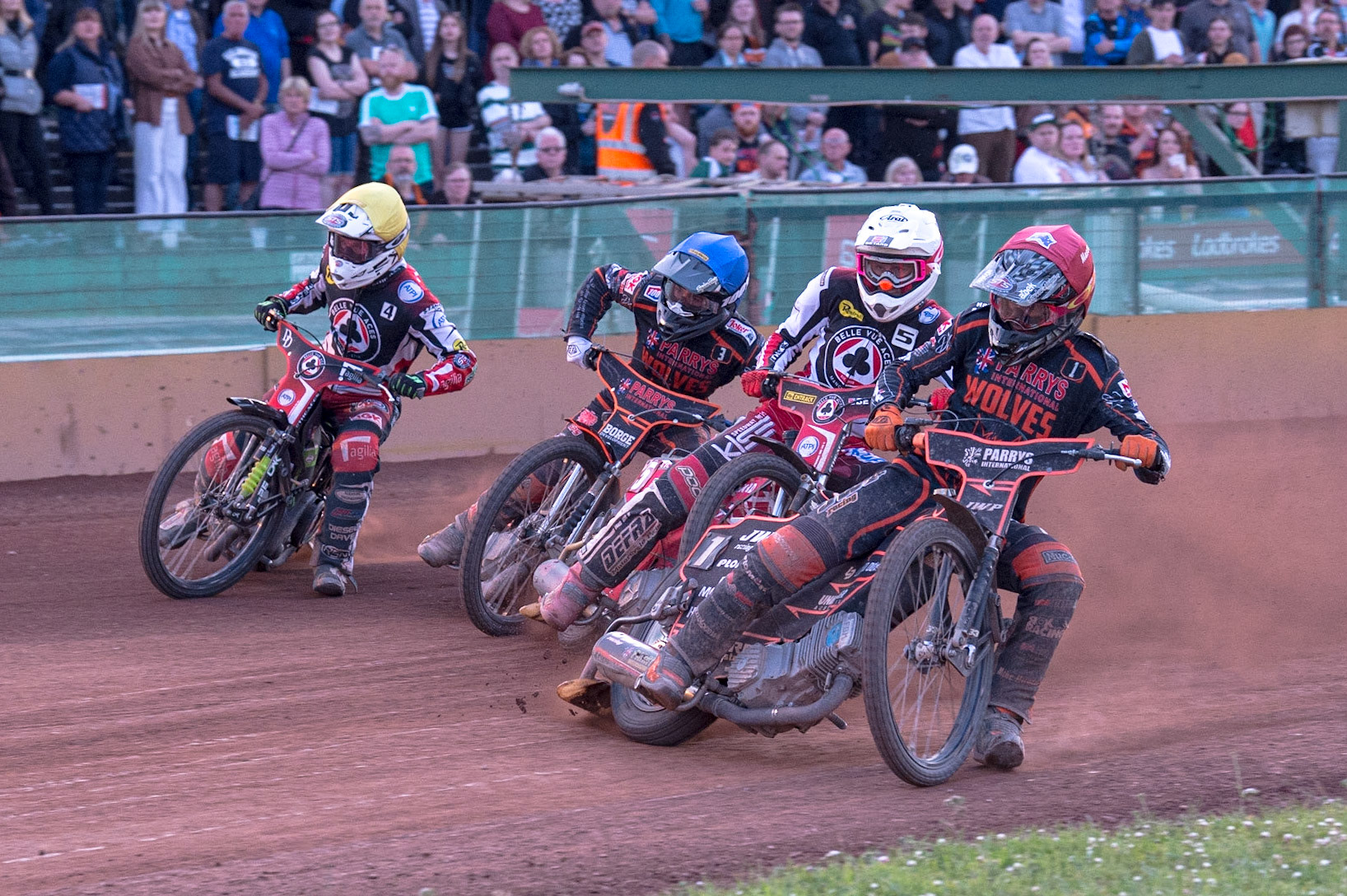 WOLVERHAMPTON, UK. JUN 20TH Sam Masters  (Red) leads Max Fricke  (White) Luke Bekker  (Blue) and Charles Wright  (Yellow) into the first turn during the SGB Premiership match between Wolverhampton Wolves and Belle Vue Aces at Monmore Green Stadium, Wolverhampton on Monday 20th June 2022. (Credit: Ian Charles | MI News)