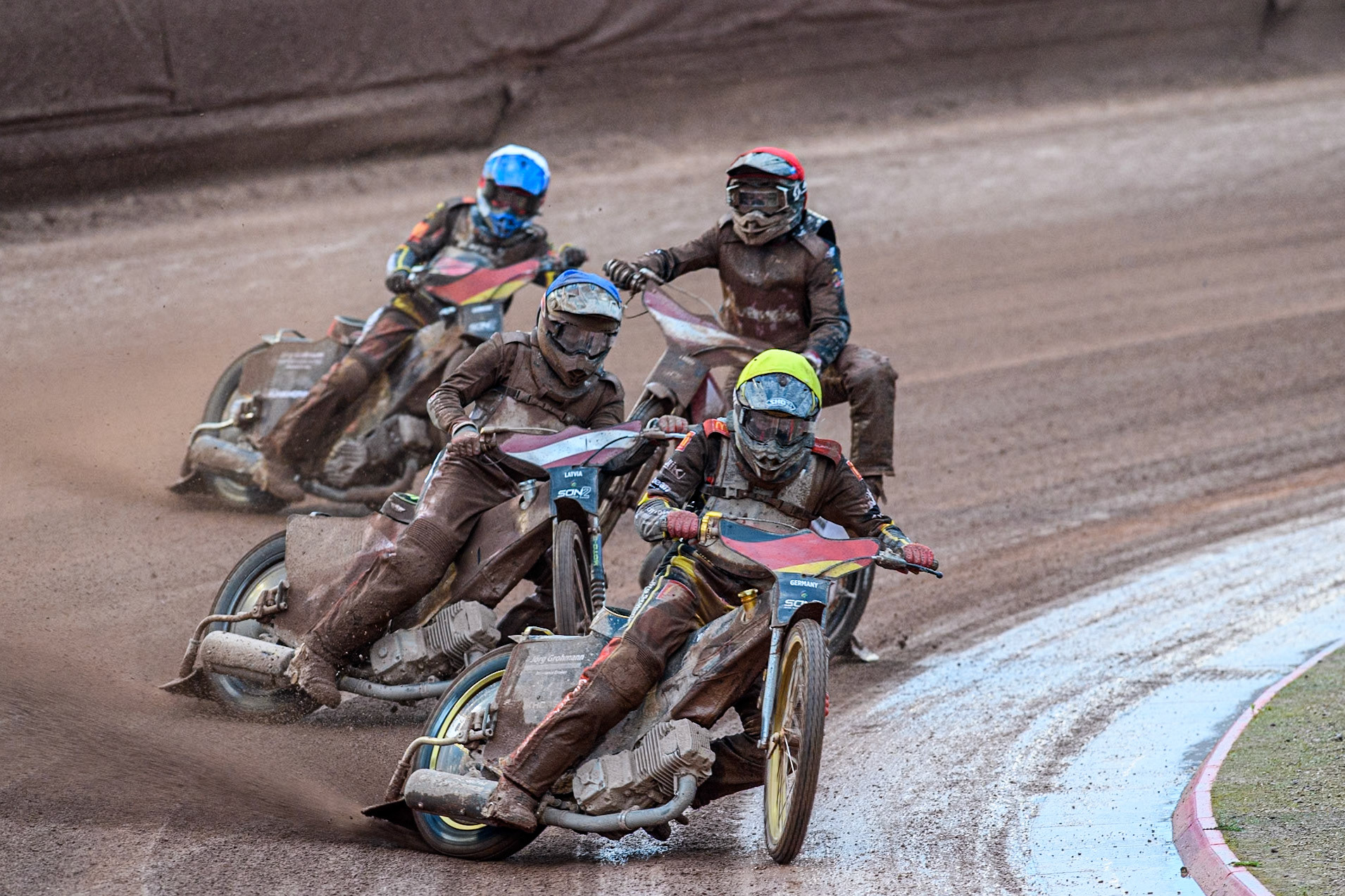 Norick Blödorn of Germany in Yellow leading Nikita Kaulins of Latvia in Blue as Artjoms Juhno of Latvia in Red picks up some drive ahead of Patrick Hyjek of Germany in White during the Monster Energy FIM Speedway of Nations 2 (Under 21) Final at the National Speedway Stadium, Manchester on Friday 12th July 2024. (Photo: Ian Charles | MI News)