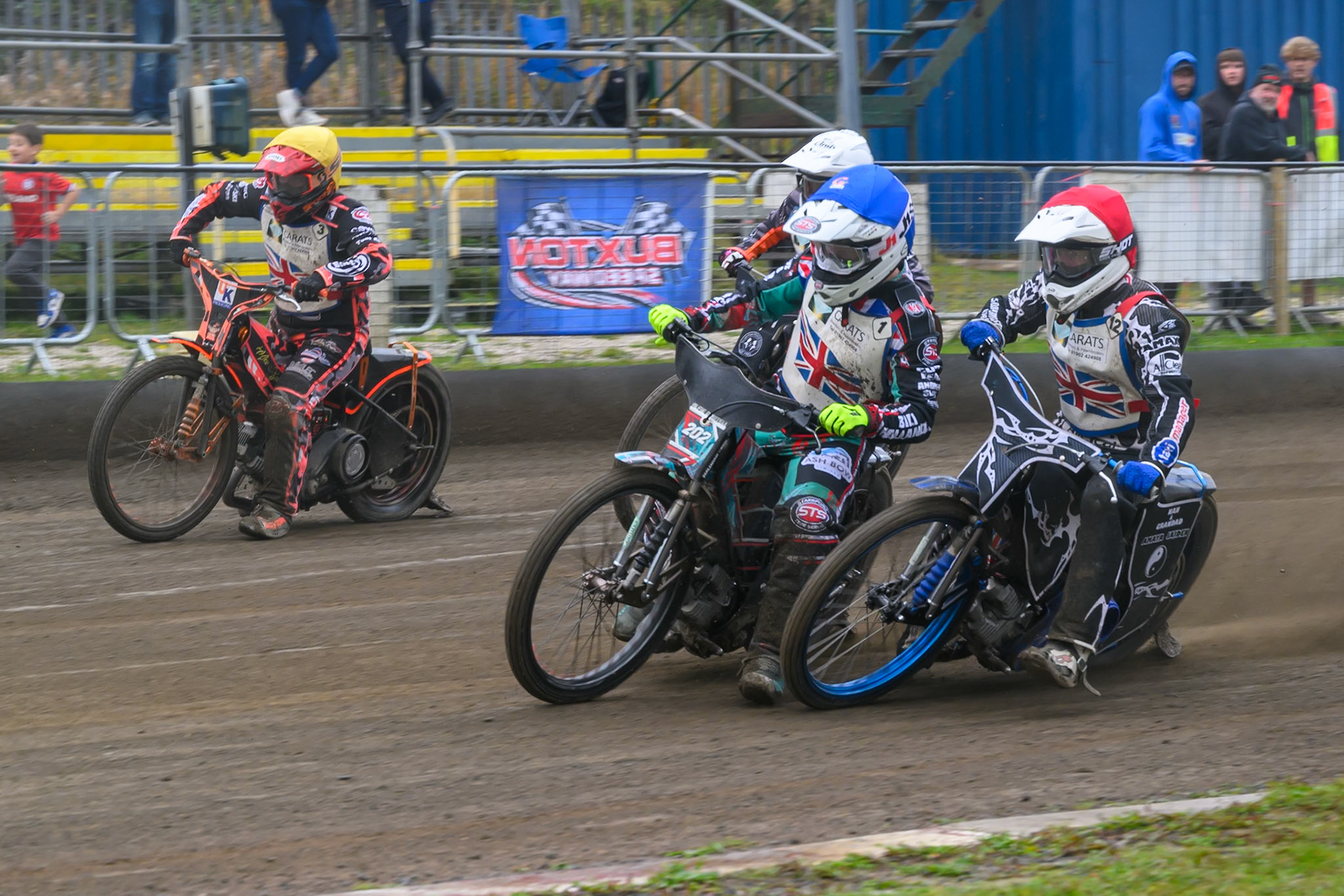 Jason Garrity in Red and Alfie Bowtell in Blue  almost come together with Alex Spooner in Yellow  on the outside and Jack Roberts  in White  behind during the Derbyshire Open at Hi-Edge Speedway, Buxton on Sunday 27th September 2026. (Photo: Ian Charles | MI News)