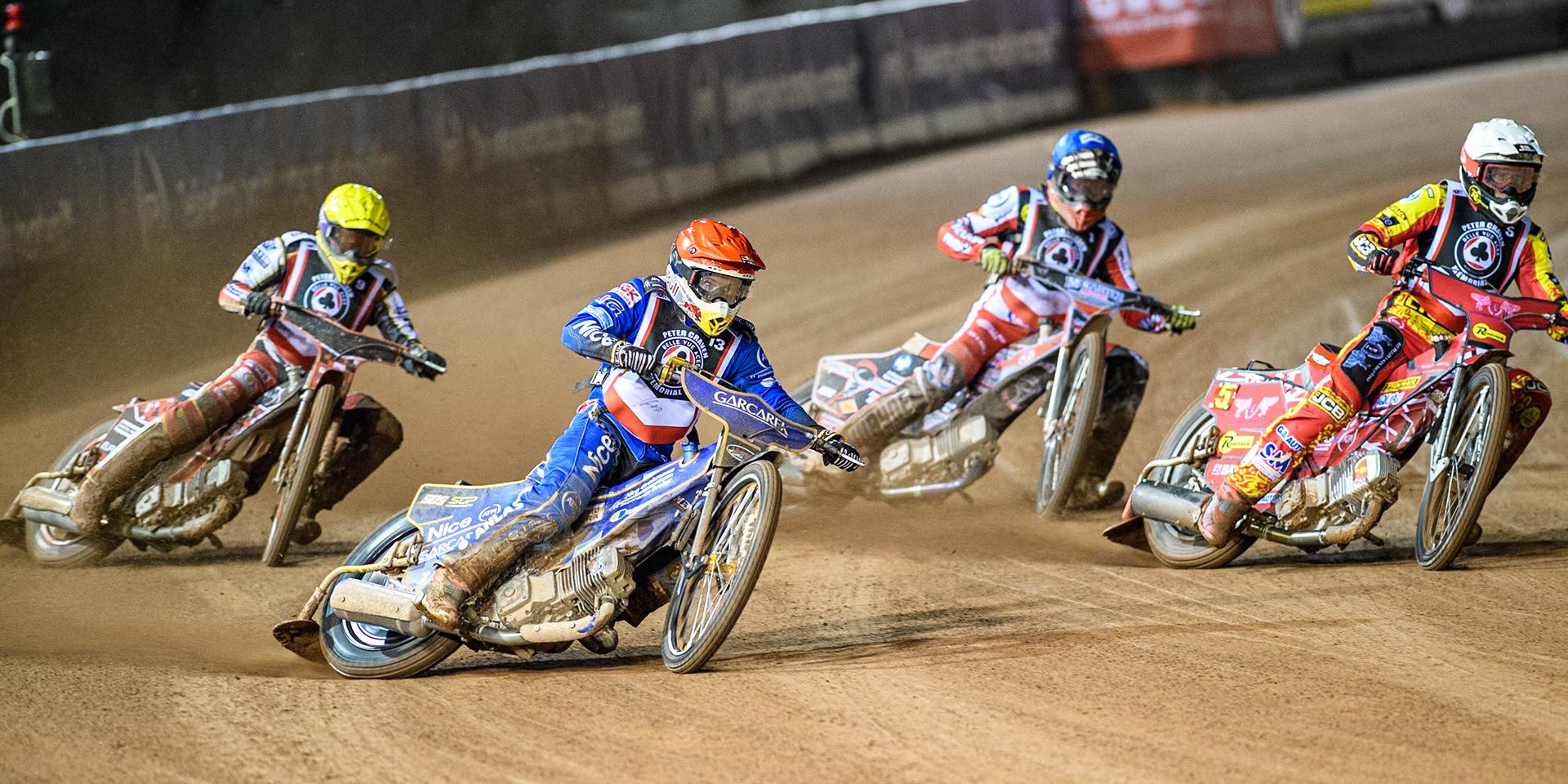 England's Robert Lambert (Red) outside Australia's Max Fricke (White) with England's Connor Bailey (Blue) and Poland's Patryk Wojdylo (Yellow) behind during the Peter Craven Memorial Trophy meeting at the National Speedway Stadium, Manchester on Monday 18th March 2024. (Photo: Ian Charles | MI News)