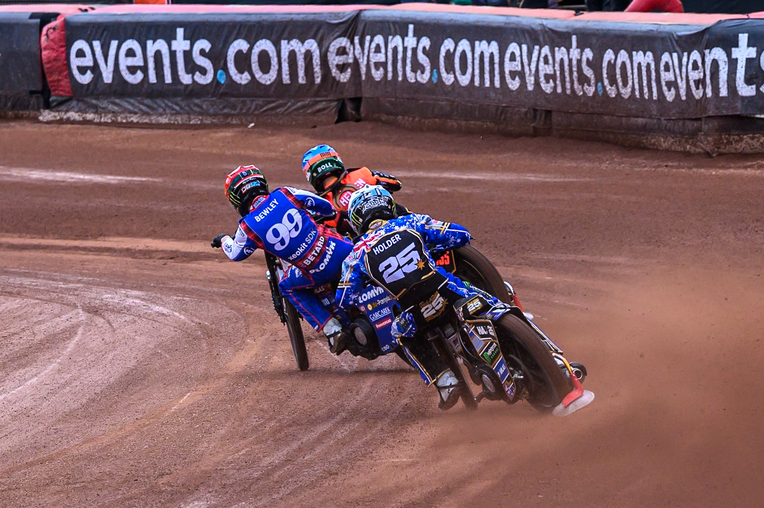 Jack Holder (25) of Australia in White chases Dan Bewley (99) of Great Britain in Red and Mikkel Michelsen (155) of Denmark in Blue during the ATPI FIM Speedway Grand Prix Round 4 at the National Speedway Stadium, Manchester, on Friday 13th June 2025. (Photo: Ian Charles | MI News)