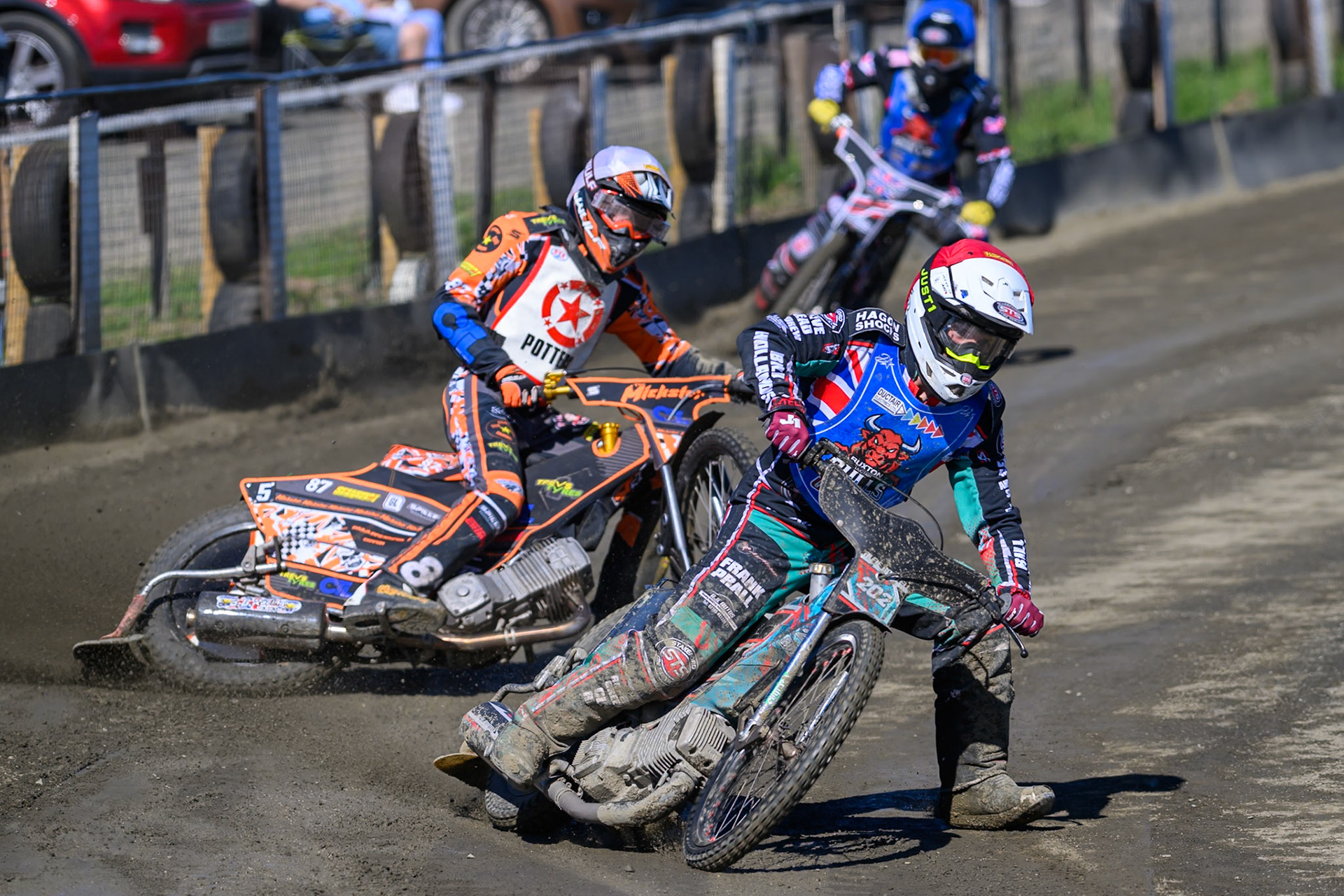 Alfie Bowtell of Buxton Bulls in Red leading Mickie Simpson of Stoke Potters in White and Jack Shimelt of Buxton Bulls  in Blue during the National Development League Challenge match between Buxton Bulls and Stoke Potters at Hi-Edge Speedway, Buxton on Sunday 24th May 2026. (Photo: Ian Charles | MI News)