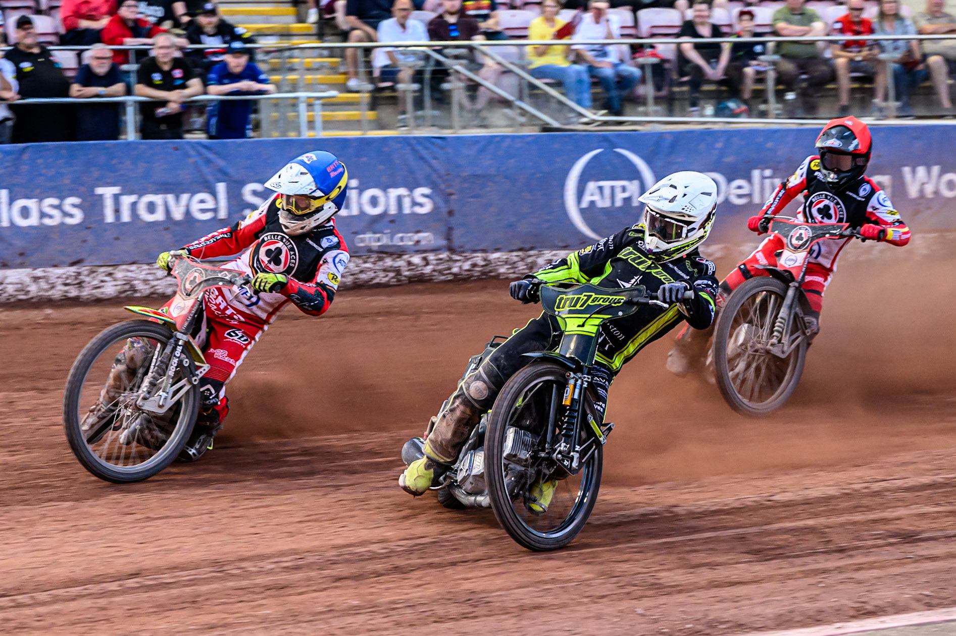 Ipswich Witches' Tom Brennan  in White rides inside Belle Vue Aces' Tate Zischke  in Blue with Belle Vue Aces' Zach Cook  in Red behind during the Rowe Motor Oil Premiership match between Belle Vue Aces and Ipswich Witches at the National Speedway Stadium, Manchester on Monday 30th June 2025. (Photo: Ian Charles | MI News)