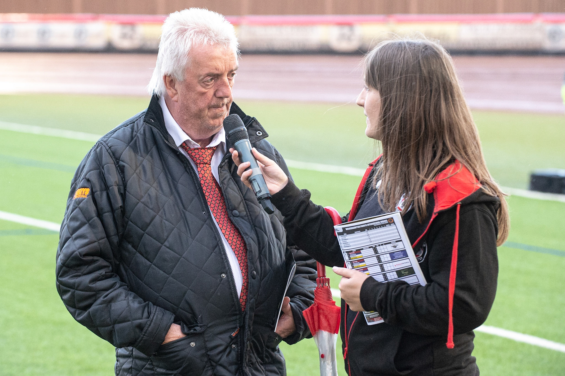 Photo by Ian Charles:

Peter Adams (left) is interviewed by Hayley

Belle Vue Aces v Wolverhampton Wolves, SGB Premiership, National Speedway Stadium, Manchester, Monday, 19, August, 2019
