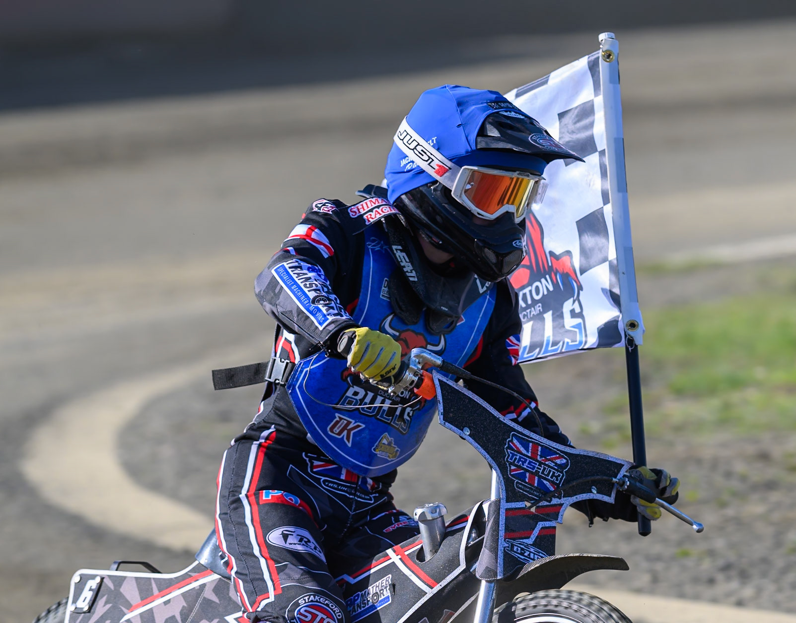 Jack Shimelt of Buxton Bulls  with the club flag after his heat win during the National Development League Challenge match between Buxton Bulls and Stoke Potters at Hi-Edge Speedway, Buxton on Sunday 24th May 2026. (Photo: Ian Charles | MI News)
