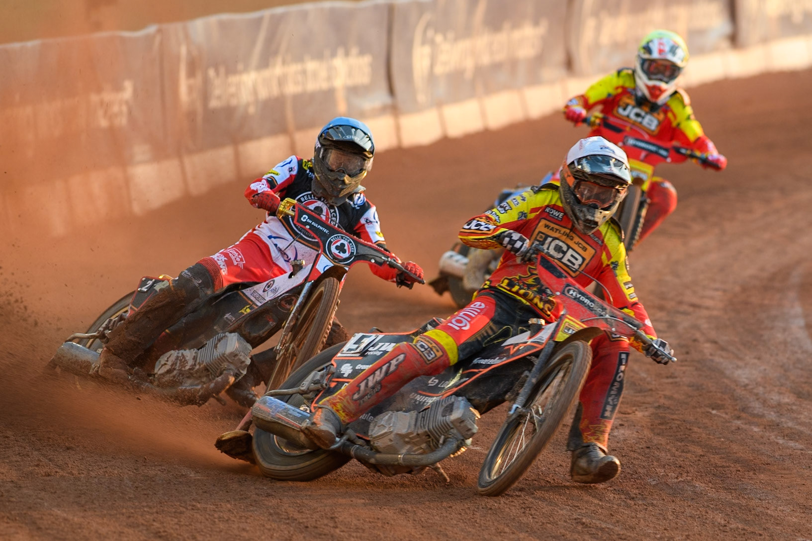Leicester Lions' Sam Masters in White leading Belle Vue Aces' Norick Blodorn in Blue and Leicester Lions' Drew Kemp in Yellow during the Rowe Motor Oil Premiership match between Belle Vue Aces and Leicester Lions at the National Speedway Stadium, Manchester on Monday 19th May 2025. (Photo: Ian Charles | MI News)