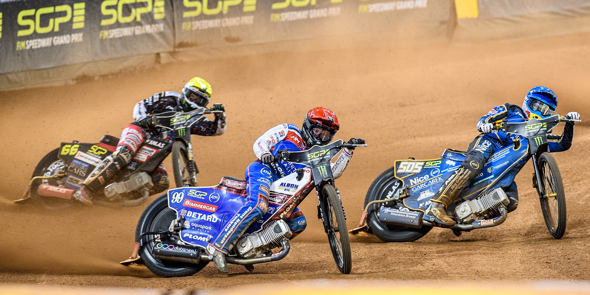Daniel Bewley (99) of Great Britain in Red rides outside Robert Lambert (505) of Great Britain in Blue with Fredrik Lindgren (66) of Sweden in Yellow behind during the FIM Speedway Grand Prix of Great Britain at The Principality Stadium, Cardiff on Saturday 17th August 2024. (Photo: Ian Charles | MI News)