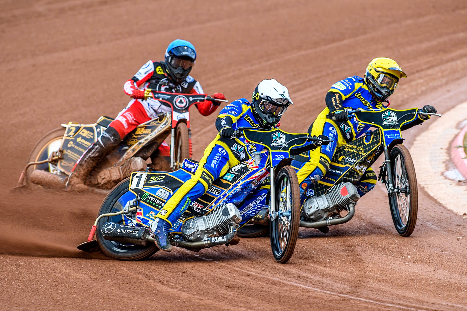 Sheffield Tigers' Jack Holder in White leading Sheffield Tigers' Kyle Howarth  in Yellow and Belle Vue Aces' Norick Blödorn  in Blue during the Rowe Motor Oil Premiership match between Belle Vue Aces and Sheffield Tigers at the National Speedway Stadium, Manchester on Monday 26th August 2024. (Photo: Ian Charles | MI News)