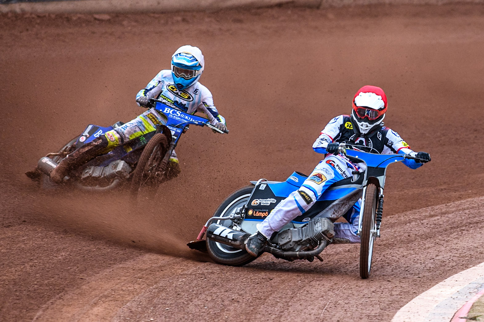 Belle Vue Aces' guest Antti Vuolas  in Red leading Oxford Spires' Ashton Boughen in White during the Rowe Motor Oil Premiership match between Belle Vue Aces and Oxford Spires at the National Speedway Stadium, Manchester on Monday 22nd July 2024. (Photo: Ian Charles | MI News)
