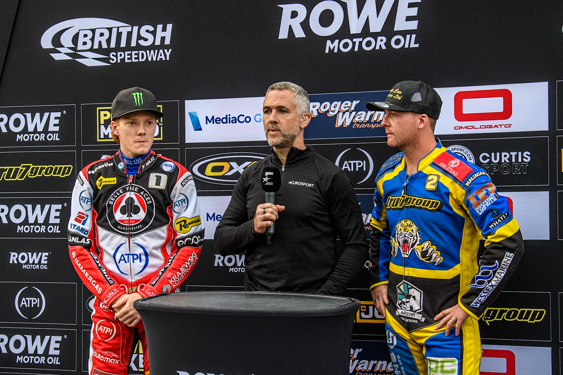 (L to R) Belle Vue Aces' Dan Bewley  , Eurosport presenter Scott Nicholls, Sheffield Tigers' Kyle Howarth  wait to do the coin toss prior to the meeting during the Rowe Motor Oil Premiership match between Sheffield Tigers and Belle Vue Aces at Owlerton Stadium, Sheffield on Monday 26th August 2024. (Photo: Ian Charles | MI News)