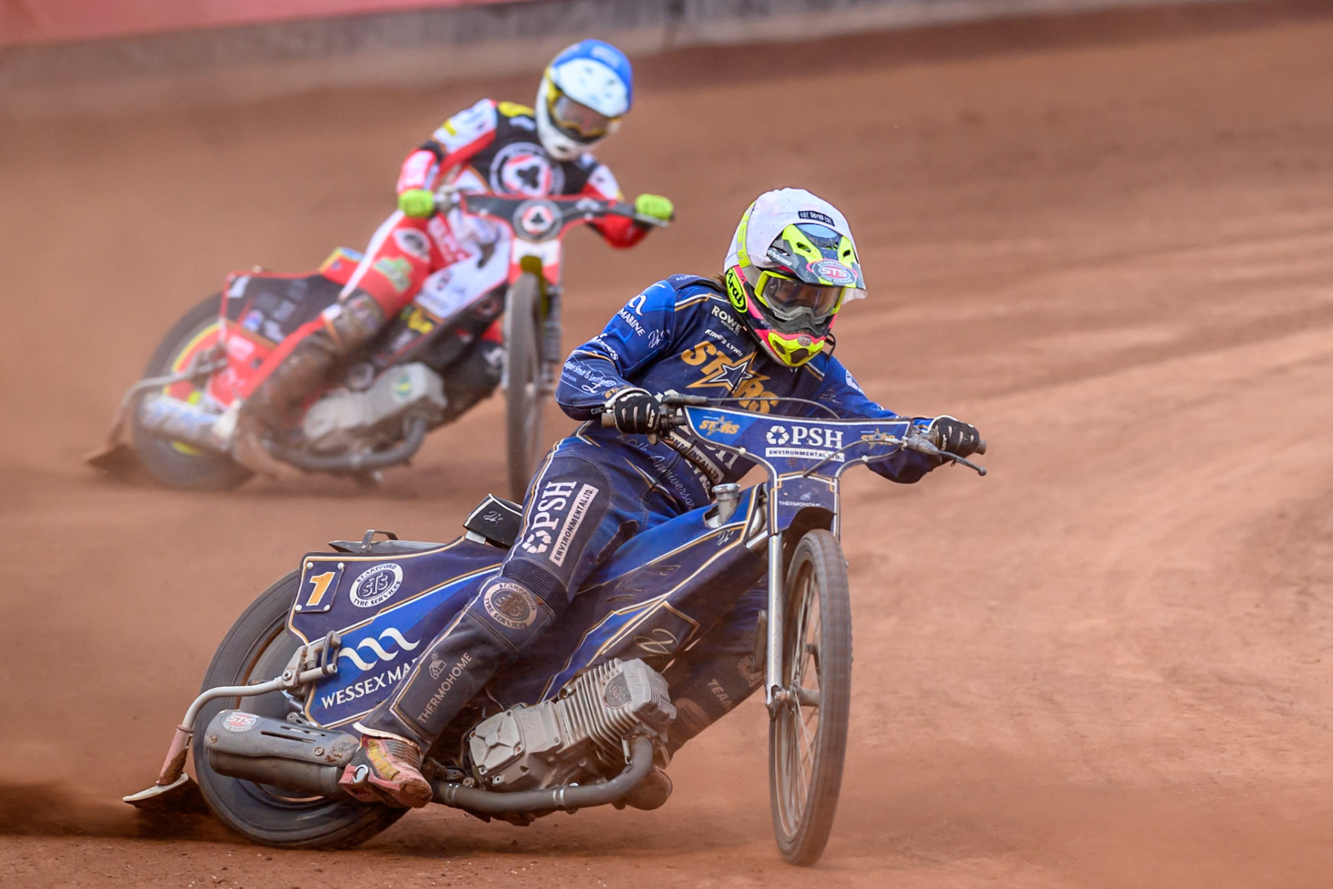 Kings Lynn Stars' Richard Lawson in White leading Belle Vue Aces' Tate Zischke in Blue during the Rowe Motor Oil Premiership match between Belle Vue Aces and King's Lynn Stars at the National Speedway Stadium, Manchester on Monday 23rd June 2025. (Photo: Ian Charles | MI News)