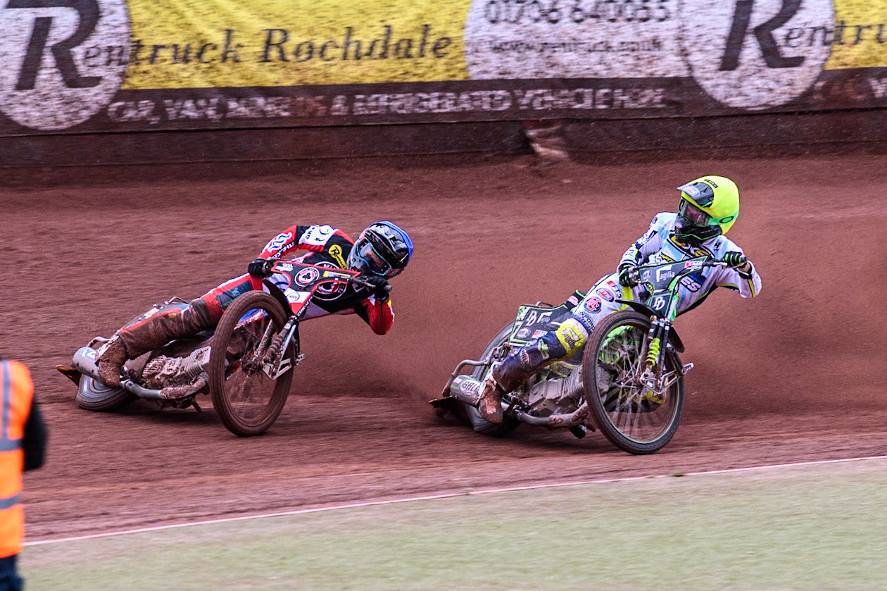 Belle Vue Aces' Ben Cook in Blue loses control after a tangle with Oxford Spires' Charles Wright in Yellow during the Rowe Motor Oil Premiership match between Belle Vue Aces and Oxford Spires at the National Speedway Stadium, Manchester on Monday 22nd July 2024. (Photo: Ian Charles | MI News)