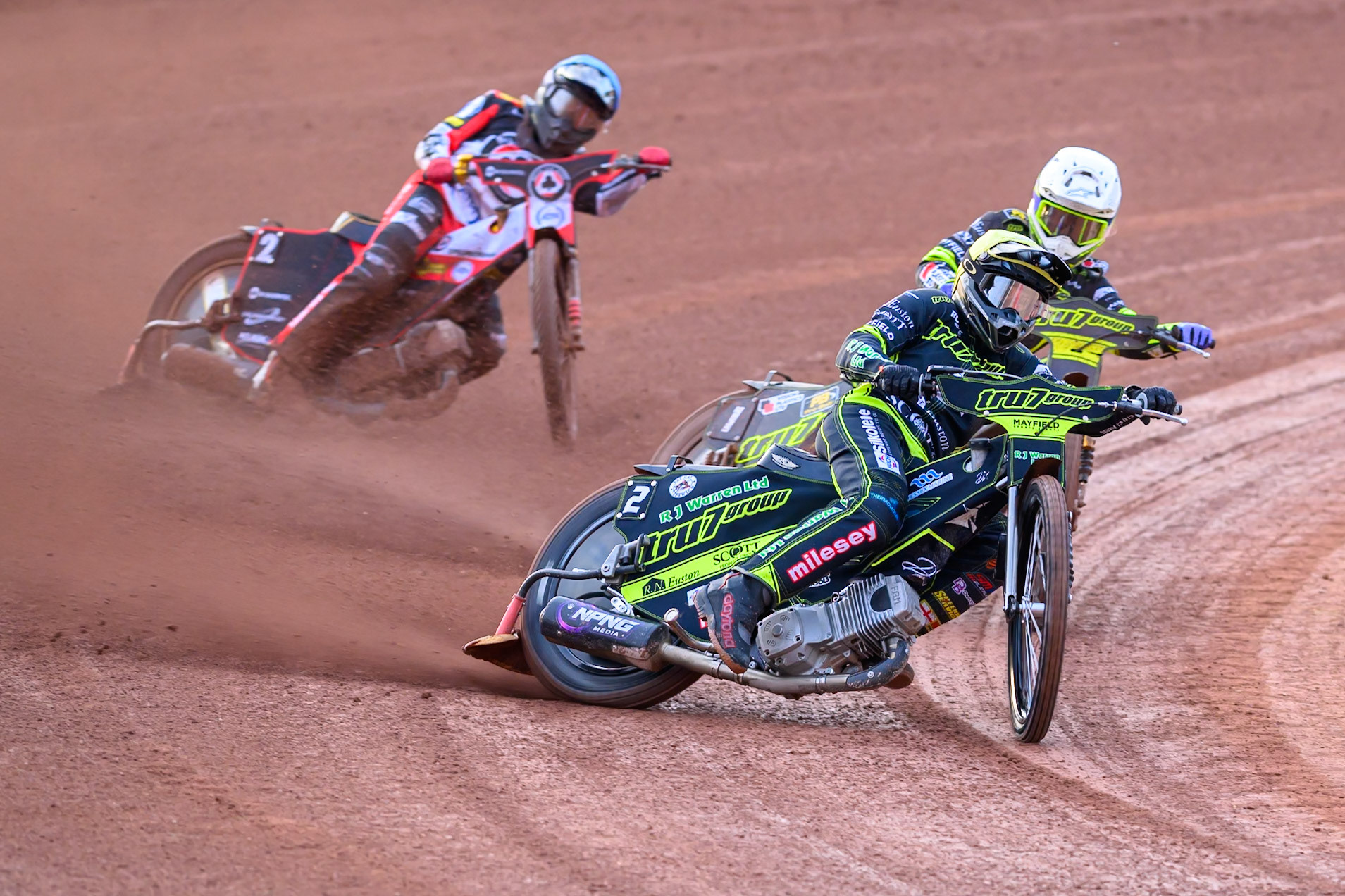 Danny King of Ipswich Witches  in Yellow leading team mate Tom Brennan of Ipswich Witches  in White, and Norick Blödorn of Belle Vue Aces  in Blue during the Rowe Motor Oil Premiership match between Belle Vue Aces and Ipswich Witches at the National Speedway Stadium, Manchester on Monday 20th April 2026. (Photo: Ian Charles | MI News)