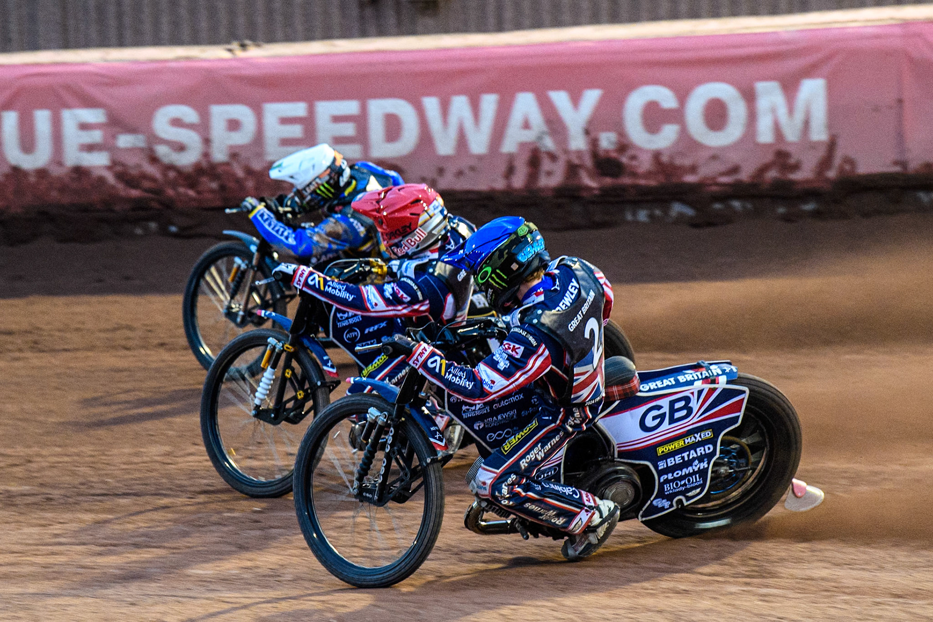 Dan Bewley of Great Britain in Blue rides inside Robert Lambert of Great Britain in Red and Fredrik Lindgren of Sweden in White during the Monster Energy FIM Speedway of Nation Final at the National Speedway Stadium, Manchester on Saturday 13th July 2024. (Photo: Ian Charles | MI News)