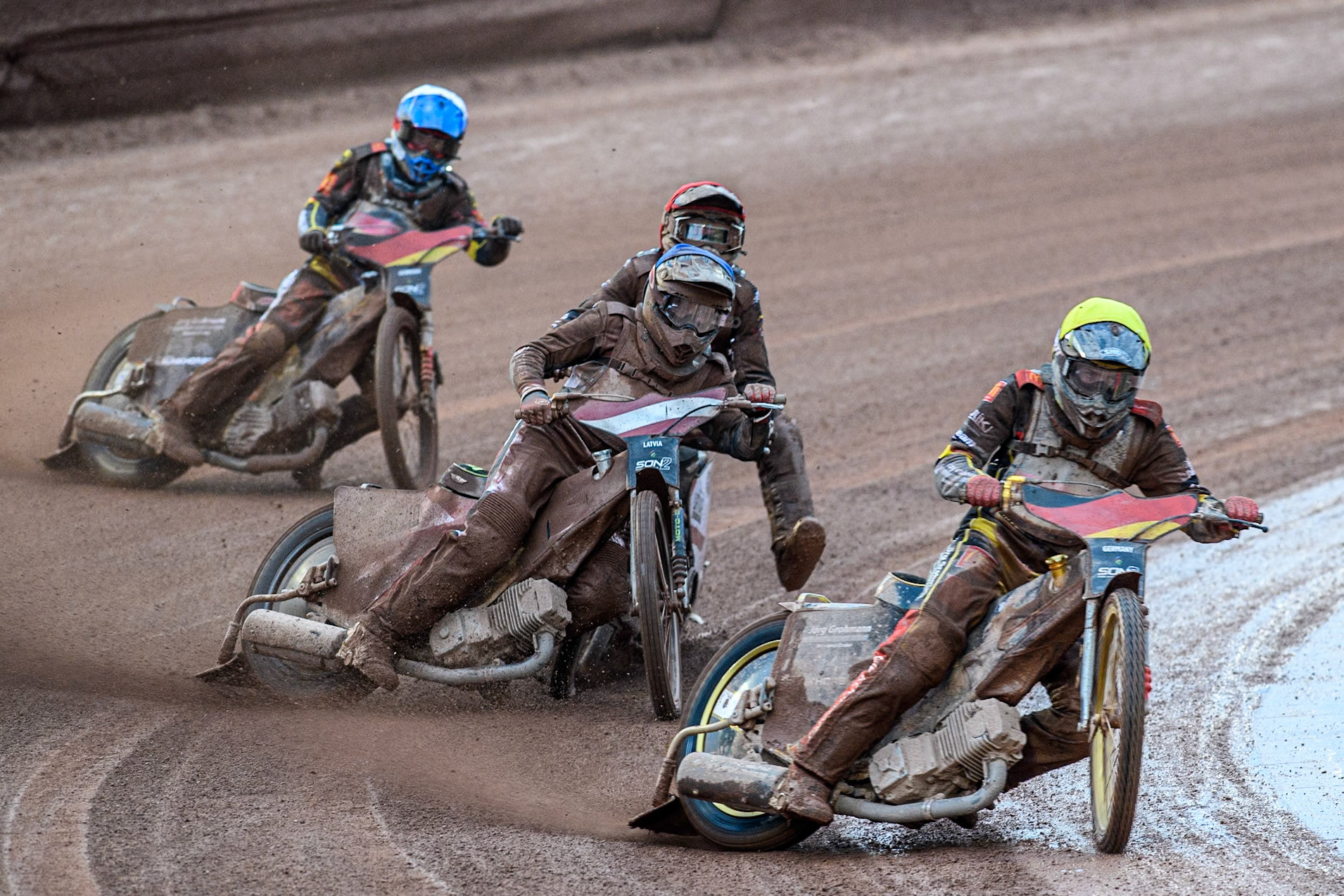 Norick Blödorn of Germany in Yellow leading Nikita Kaulins of Latvia in Blue as Artjoms Juhno of Latvia in Red picks up some drive ahead of Patrick Hyjek of Germany in White during the Monster Energy FIM Speedway of Nations 2 (Under 21) Final at the National Speedway Stadium, Manchester on Friday 12th July 2024. (Photo: Ian Charles | MI News)