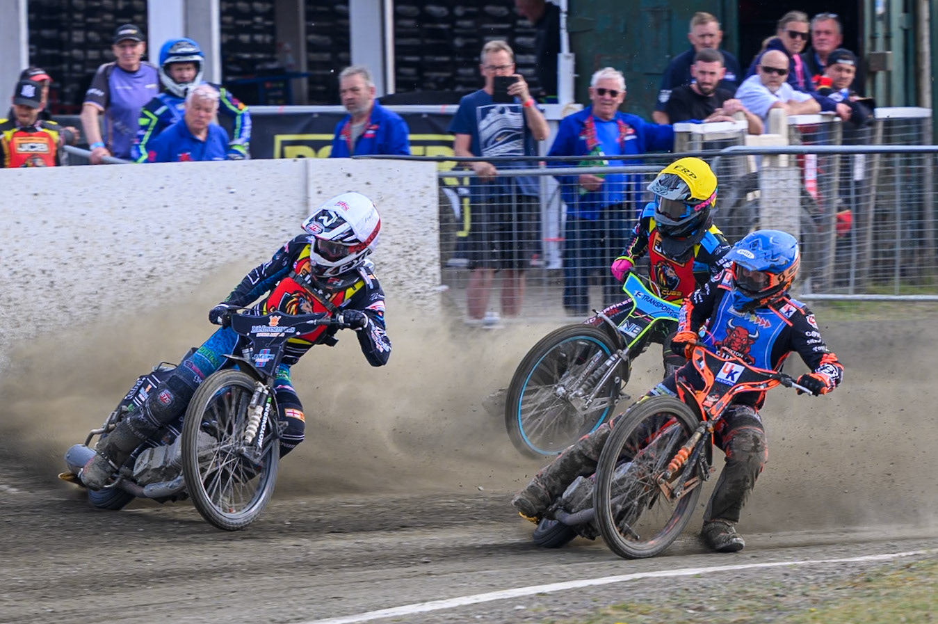 Alex Spooner of Buxton Bulls  in Blue rides inside Freddy Hodder of Leicester Lion Cubs  in White and Eli Meadows of Leicester Lion Cubs in Yellow  during the Challenge match between Buxton Bulls and Leicester Lion Cubs at Hi-Edge Speedway, Buxton on Sunday 26th April 2026. (Photo: Ian Charles | MI News)
