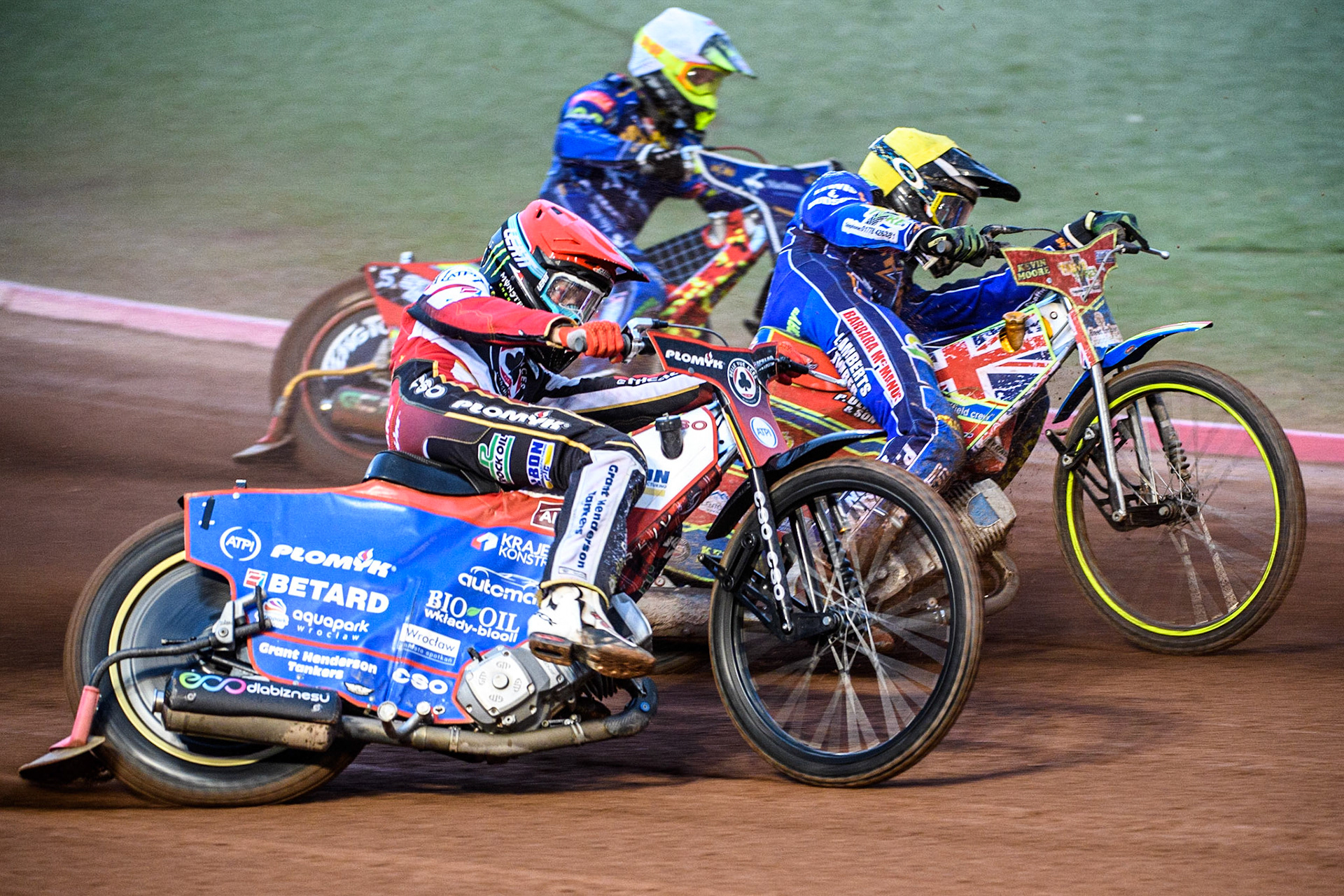 Dan Bewley (Red) outside Simon Lambert (Yellow) and Michael Palm Toft (White) during the Sports Insure Premiership match between Belle Vue Aces and King's Lynn Stars at the National Speedway Stadium, Manchester on Monday 21st August 2023. (Photo: Ian Charles | MI News)