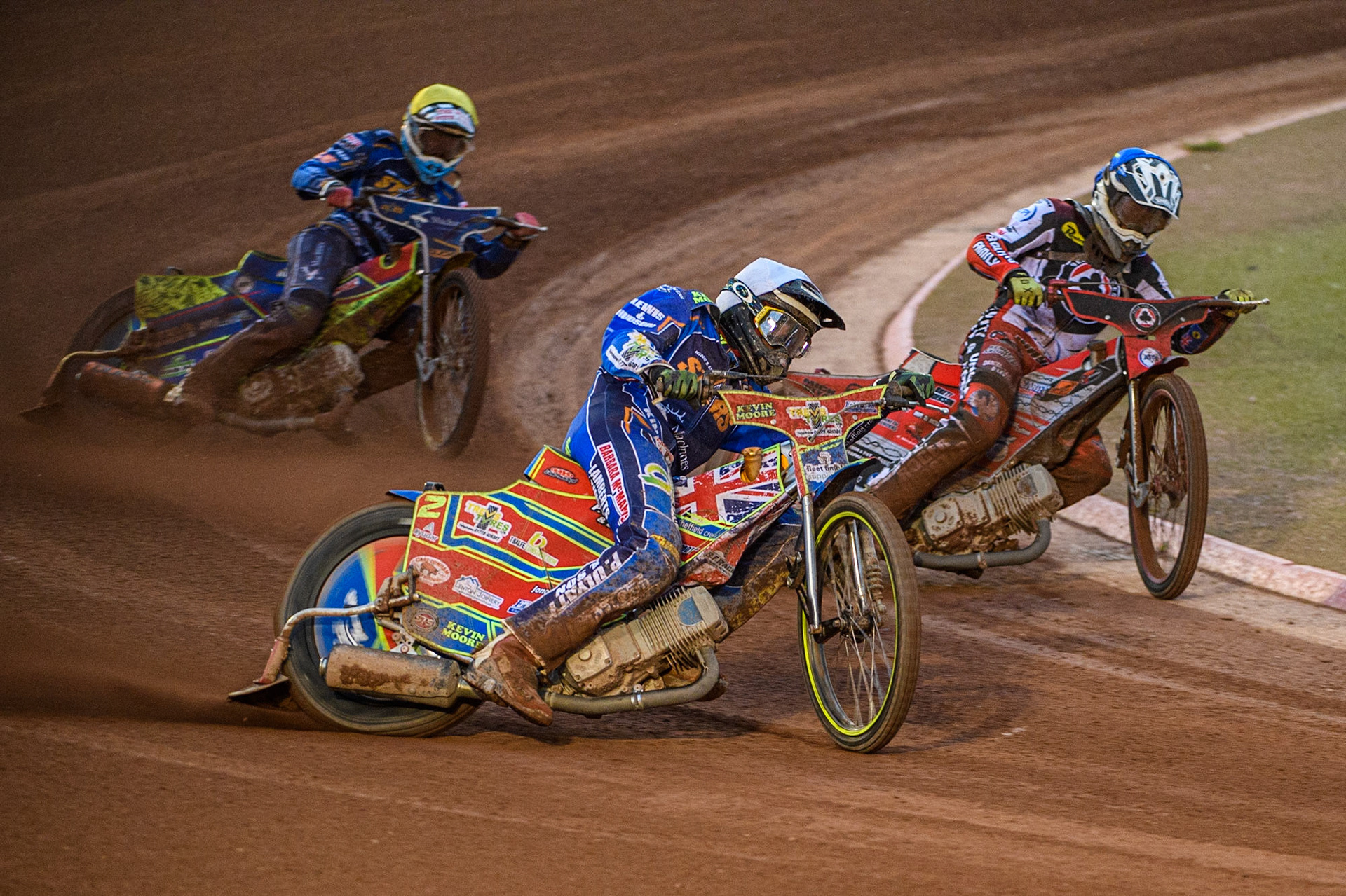 Simon Lambert (White) outside Connor Bailey (Blue) with Anders Rowe (Yellow) behind during the Sports Insure Premiership match between Belle Vue Aces and King's Lynn Stars at the National Speedway Stadium, Manchester on Monday 21st August 2023. (Photo: Ian Charles | MI News)