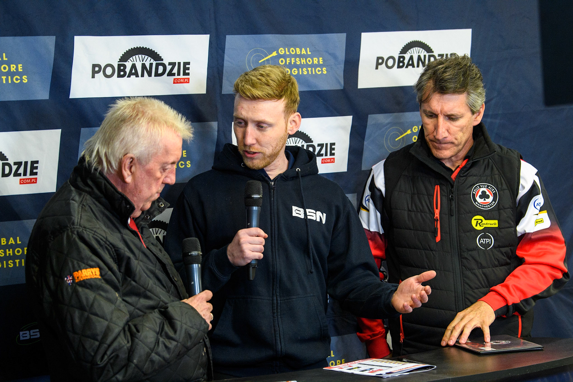 BSN Presenter (Centre) interviewed Parry's International Wolves Team Manager Peter Adams (left) whilst Mark Lemon (right) waits his turn during the Sports Insure Premiership Knock Out Cup Quarter Final 2nd Leg between Belle Vue Aces and Wolverhampton Wolves at the National Speedway Stadium, Manchester on Thursday 18th May 2023. (Photo: Ian Charles | MI News)