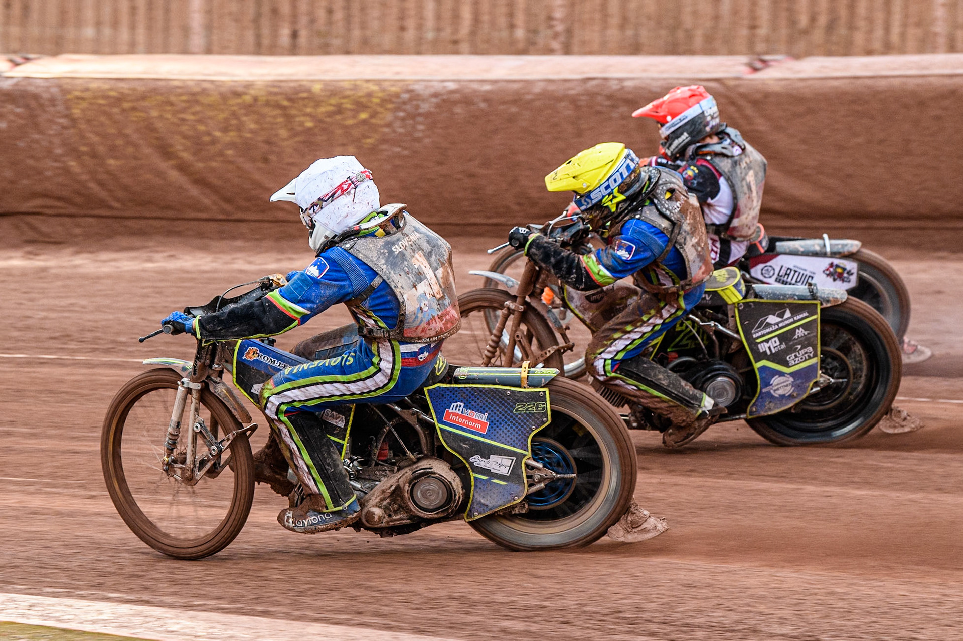 Anze Grmek of Slovenia in White rides inside Matic Ivacic of Slovenia in Yellow and Andzejs Lebedevs of Latvia in Red during the Monster Energy FIM Speedway of Nation Semi Final 2 at the National Speedway Stadium, Manchester on Wednesday 10th July 2024. (Photo: Ian Charles | MI News)