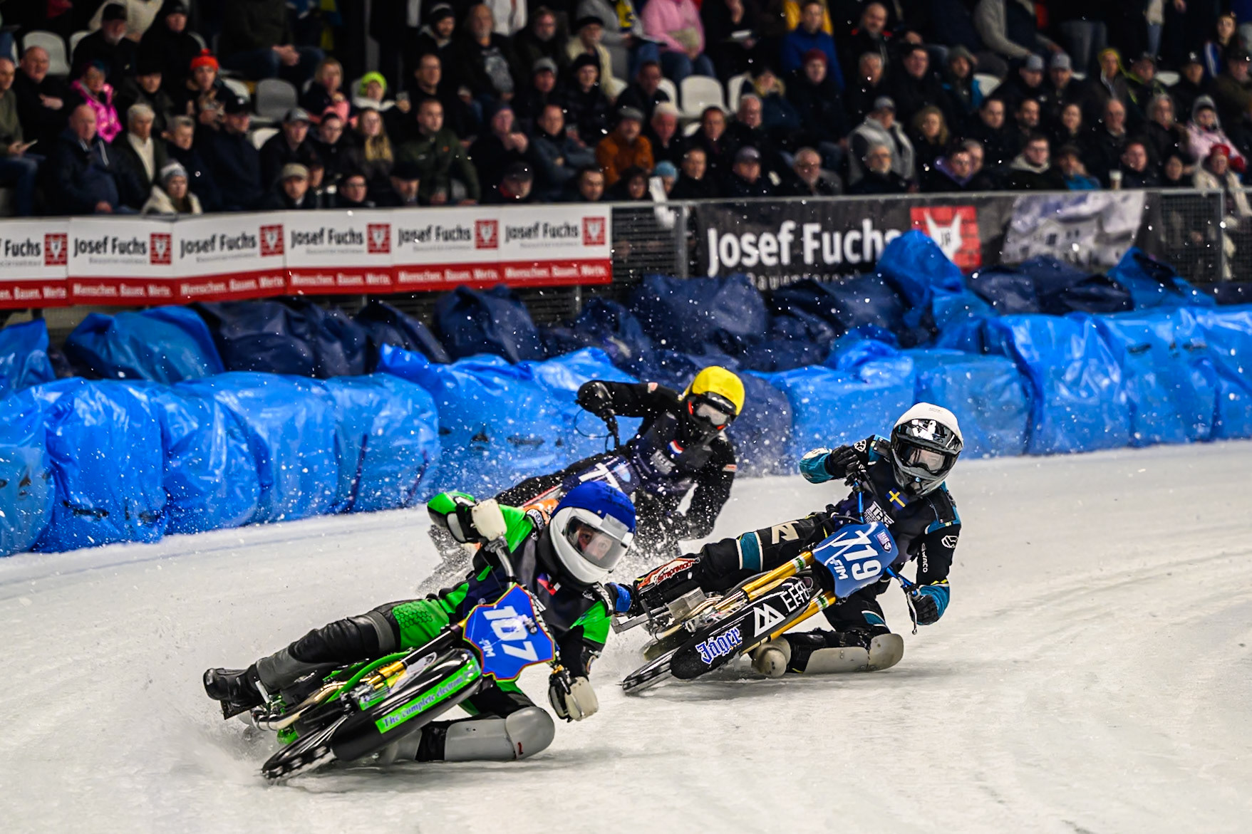 Andrej Divis (107) of Czechia  in Blue leading Filip Jäger (719) of Sweden in White and Leon Kramer (777) of The Netherlands in Yellow during the Ice Speedway Gladiators World Championship Final 1 at Max-Aicher-Arena, Inzell on Saturday 14th March 2026. (Photo: Ian Charles | MI News)