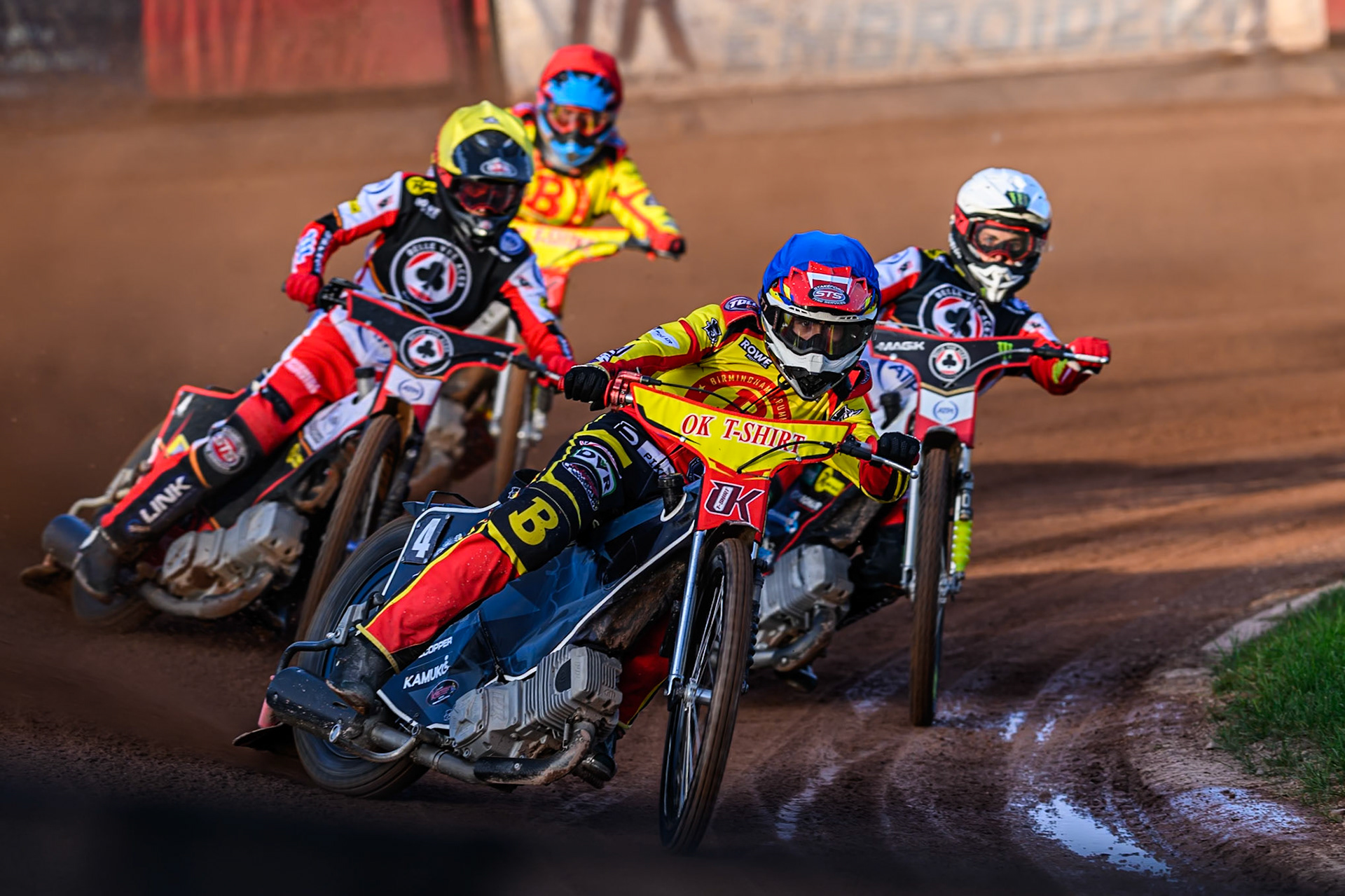 Birmingham Brummies' Keynan Rew  in Blue leading Belle Vue Aces' Zach Cook  in Yellow, Belle Vue Aces' Jaimon Lidsey in White and Birmingham Brummies' Jonas Jeppesen  in Red during the Rowe Motor Oil Premiership match between Birmingham Brummies and Belle Vue Aces at Perry Barr Stadium, Birmingham on Monday 28th July 2025. (Photo: Ian Charles | MI News)