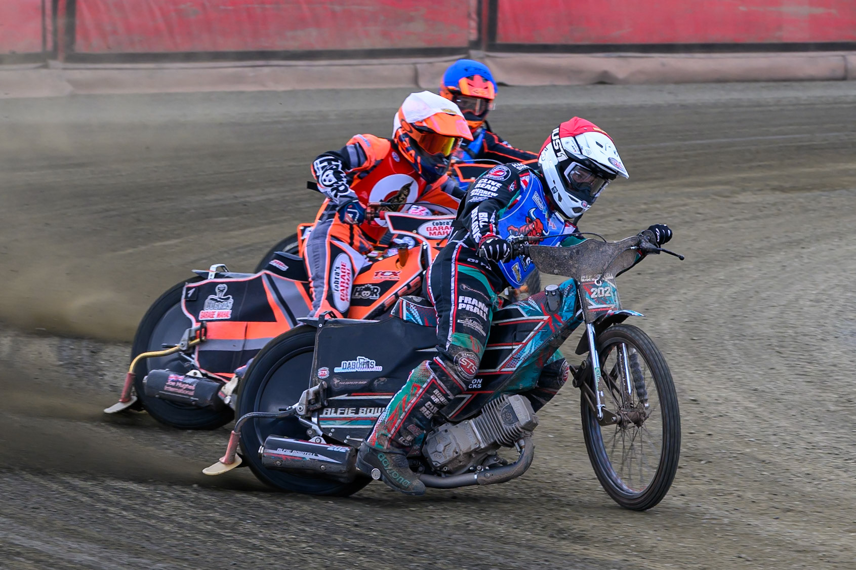 Alfie Bowtell of Buxton Bulls  in Red leading Connor Coles of NDL Nomads   in White and Jack Smith of Buxton Bulls   in Blue during the  Challenge match between Buxton Bulls and NDL Nomads at Hi-Edge Speedway, Buxton on Sunday 19th April 2026. (Photo: Ian Charles | MI News)