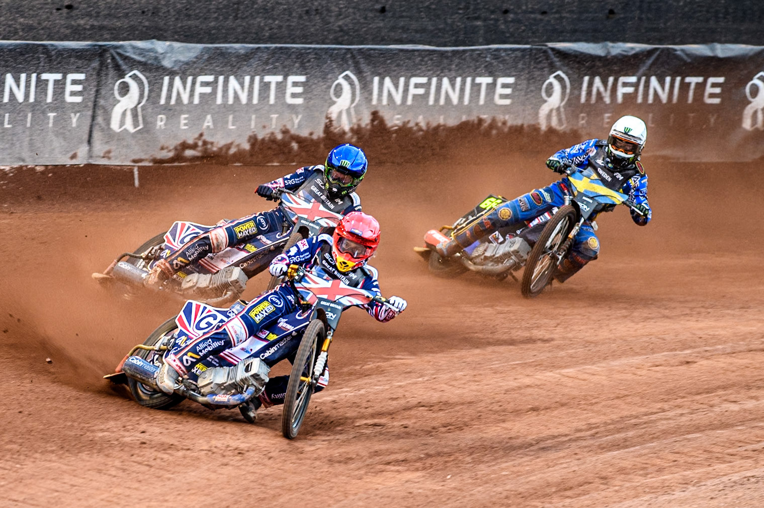 GREAT BRITAIN v SWEDEN: Robert Lambert of Great Britain in Red and Dan Bewley of Great Britain in Blue leading Fredrik Lindgren of Sweden in White during the Monster Energy FIM Speedway of Nation Final at the National Speedway Stadium, Manchester on Saturday 13th July 2024. (Photo: Ian Charles | MI News)