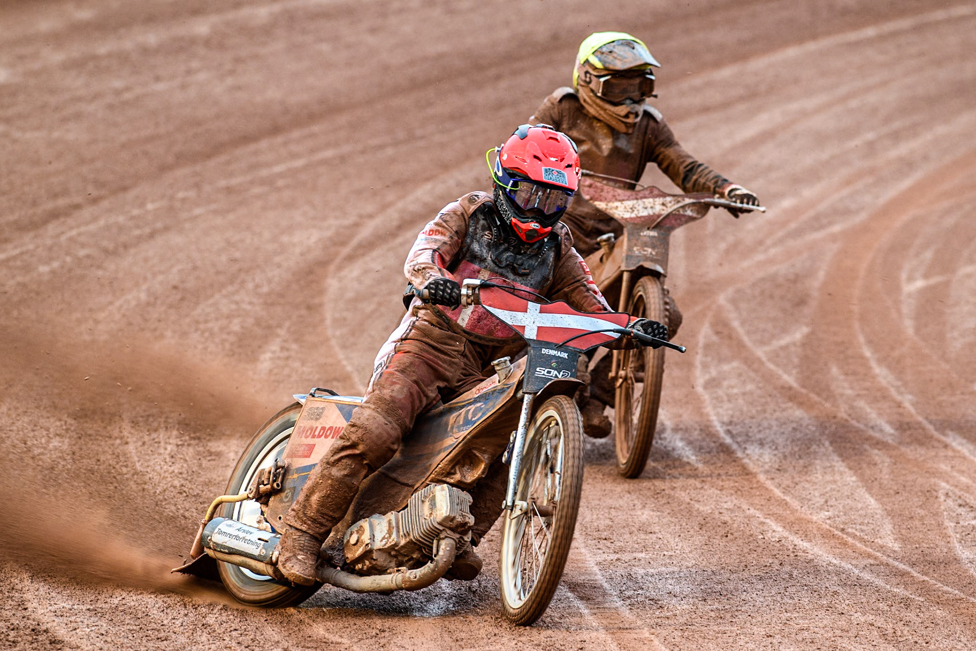 Bastian Pedersen of Denmark in Red leading Artjoms Juhno of Latvia in Yellow during the Monster Energy FIM Speedway of Nations 2 (Under 21) Final at the National Speedway Stadium, Manchester on Friday 12th July 2024. (Photo: Ian Charles | MI News)