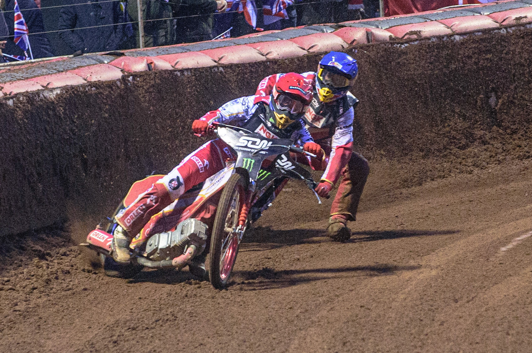 MANCHESTER, UK. OCT 17TH The moment Great Britain became champions as \pl1\ (Red) causes team mate Maciej Janowski (Blue) to hit the dirt during the Monster Energy FIM Speedway of Nations at the National Speedway Stadium, Manchester on Sunday  17th October 2021. (Credit: Ian Charles | MI News)
