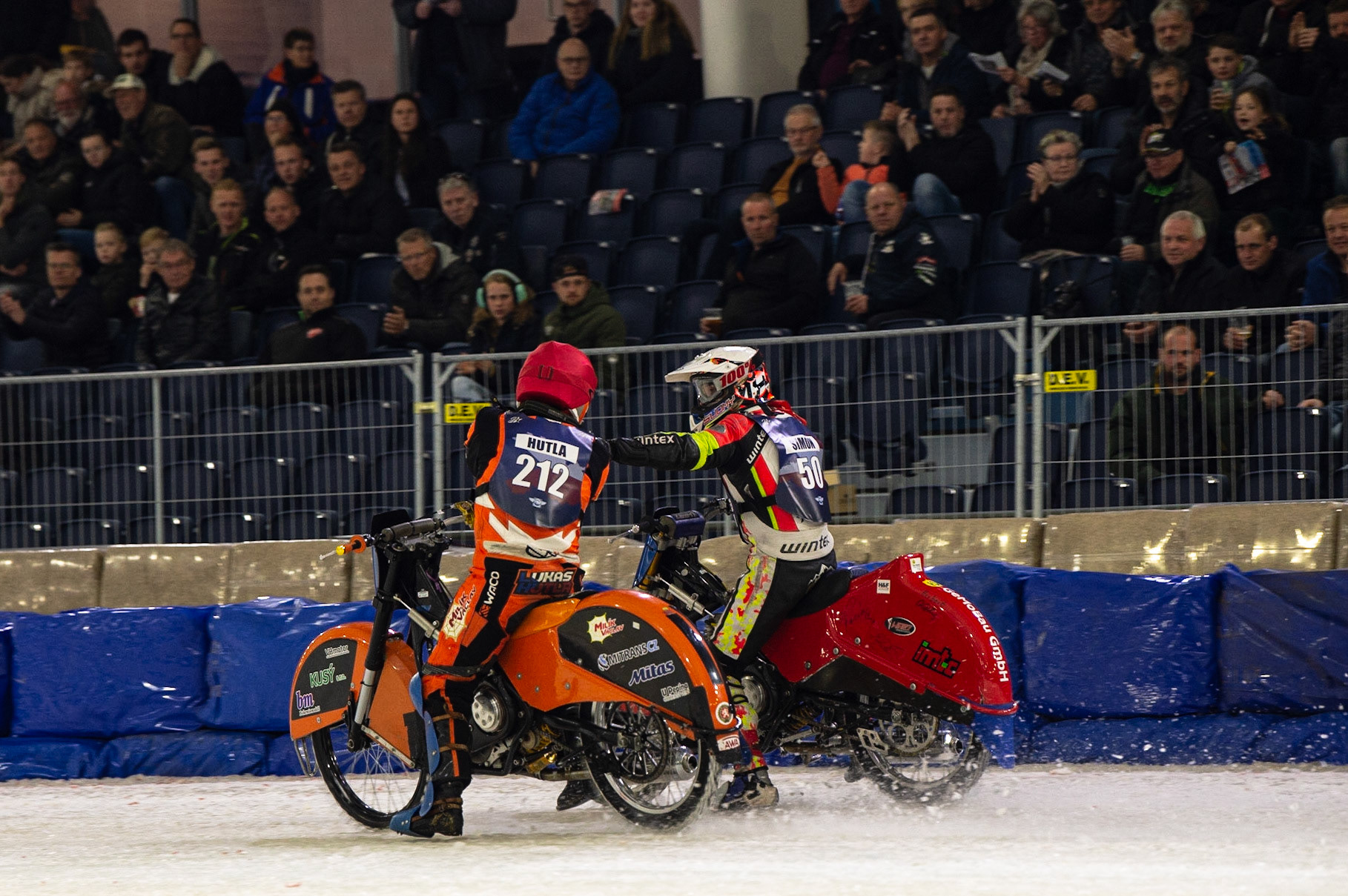 HEERENVEEN, NL. Lukas Hutla (212) congratulates Harald Simon (50) on his win during the FIM Ice Speedway Gladiators World Championship Final 3 at Ice Rink Thialf, Heerenveen on Saturday  2 April 2022. (Credit: Ian Charles | MI News)