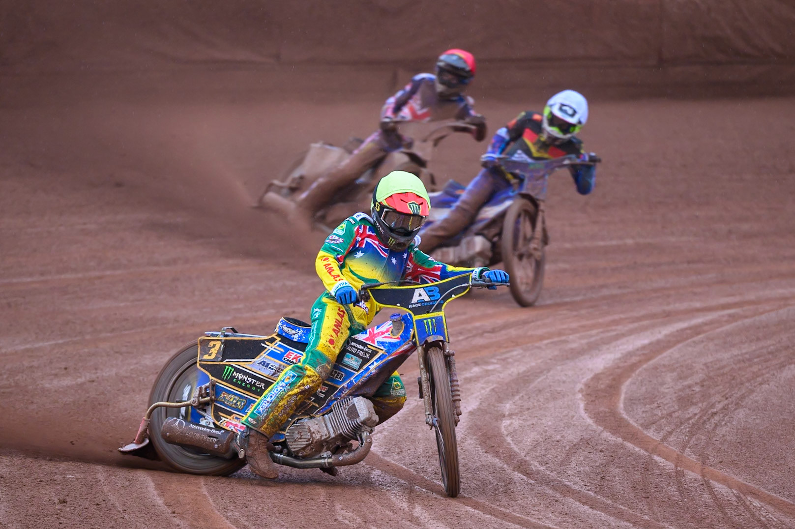 Jack Holder of Australia in White leading Mario Hausl of Germany in Yellow and Adam Ellis of Great Britain in Red during the Speedway GP Qualifying Round 3 at Allied Ashfield Stadium, Glasgow on Saturday 30th May 2026. (Photo: Ian Charles | MI News)