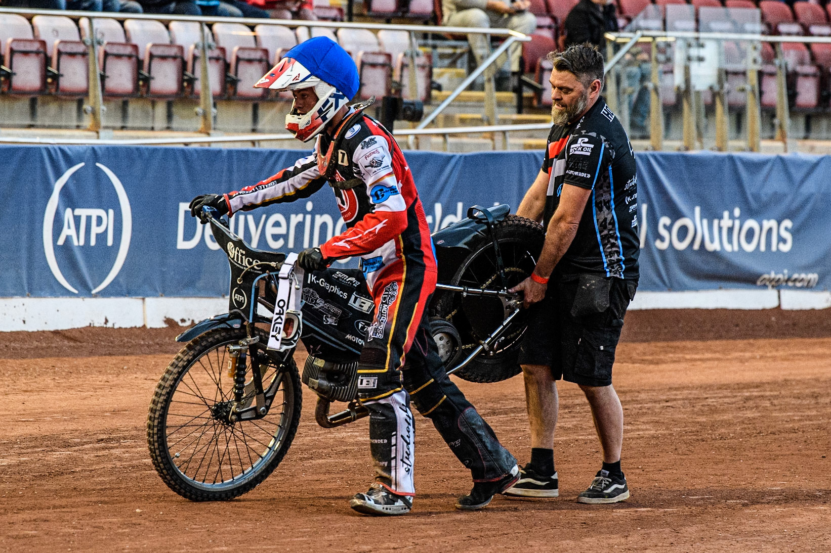 Freddy Hodder and his father carry the failed bike off the track after the heat. The clutch had failed during the National Development League match between Belle Vue Colts and Mildenhall Fens Tigers at the National Speedway Stadium, Manchester on Friday 26th May 2023. (Photo: Ian Charles | MI News)