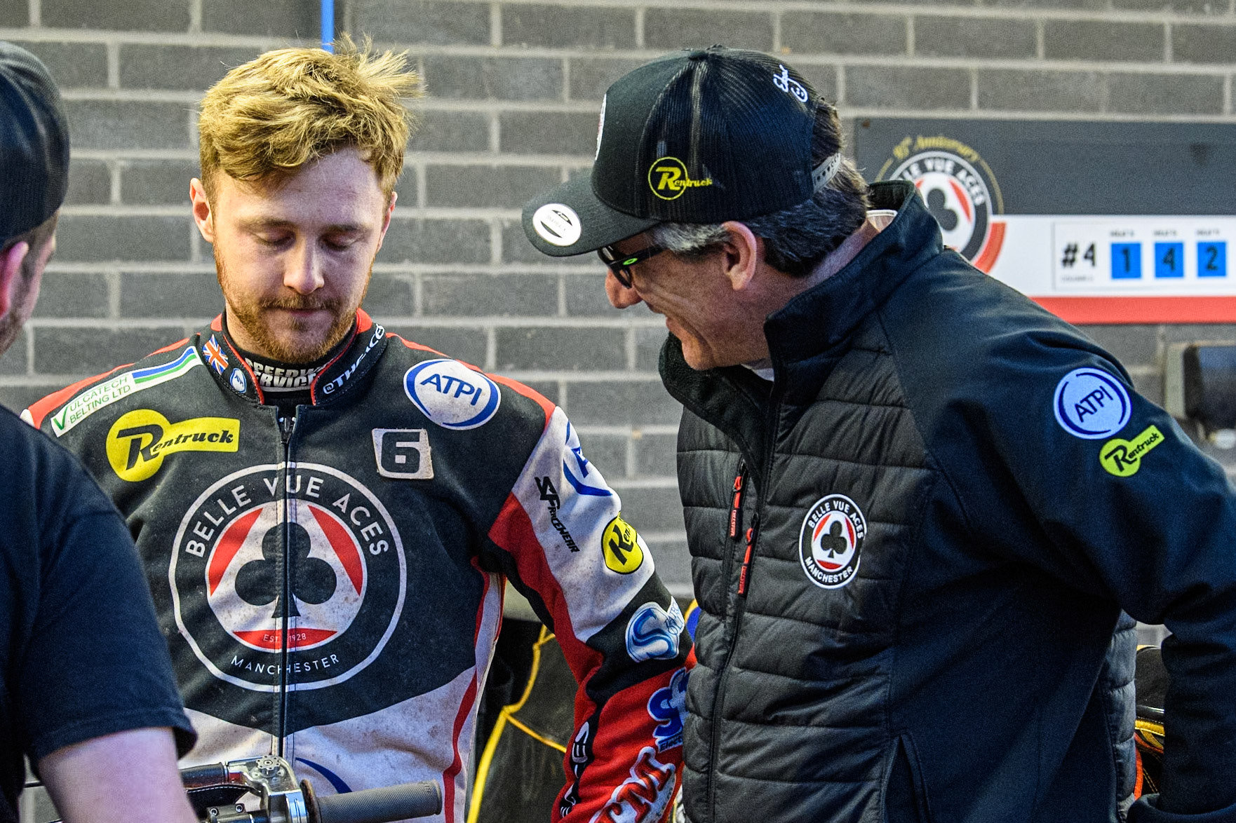 Belle Vue Aces' Connor Mountain (Left) chats with Belle Vue Aces' Team Manager Mark Lemon during the Rowe Motor Oil Premiership match between Belle Vue Aces and King's Lynn Stars at the National Speedway Stadium, Manchester on Monday 20th May 2024. (Photo: Ian Charles | MI News)