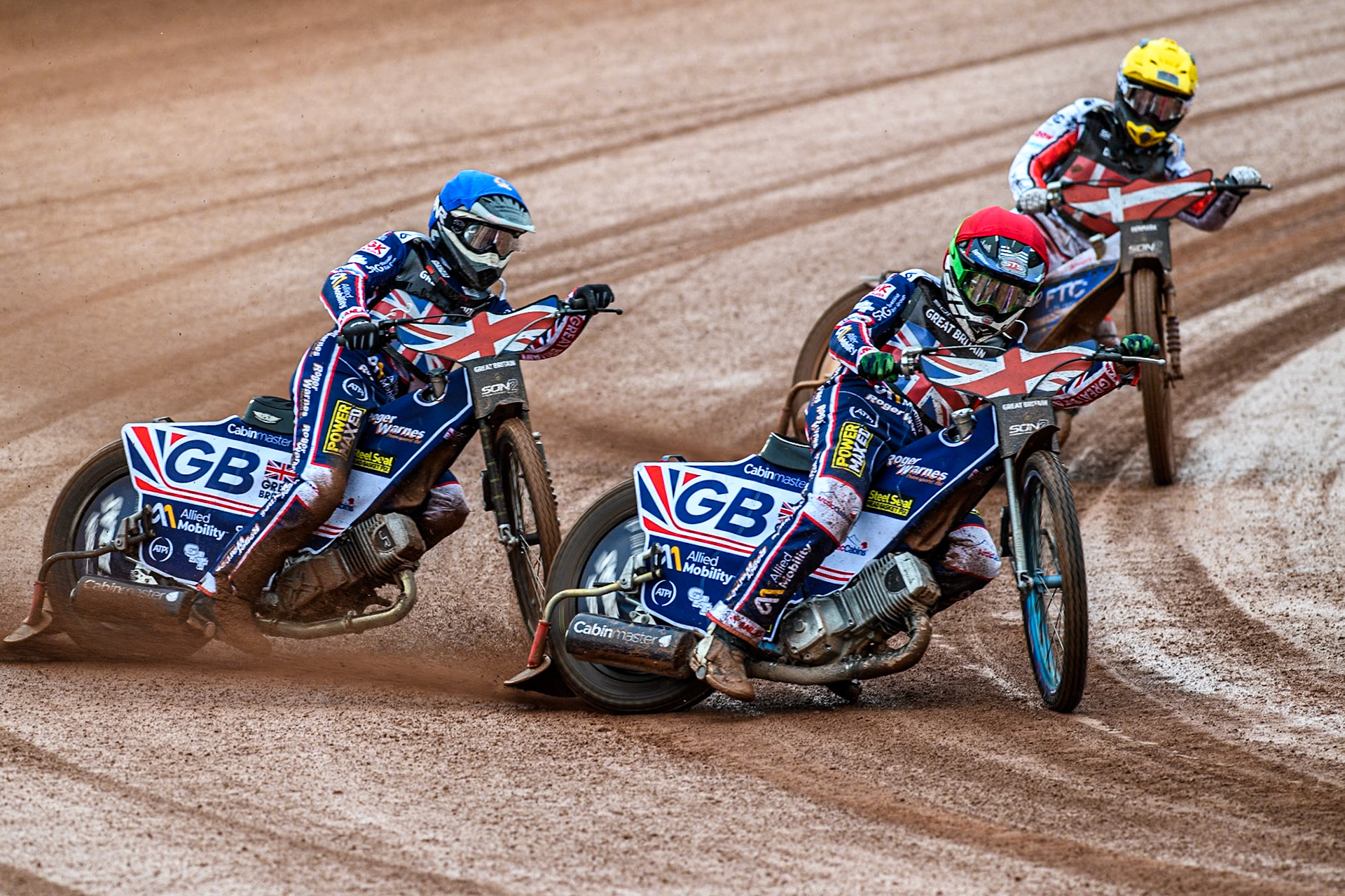 Leon Flint of Great Britain in Red and Dan Thompson of Great Britain leading Bastian Pedersen of Denmark in Yellow during the Monster Energy FIM Speedway of Nations 2 (Under 21) Final at the National Speedway Stadium, Manchester on Friday 12th July 2024. (Photo: Ian Charles | MI News)