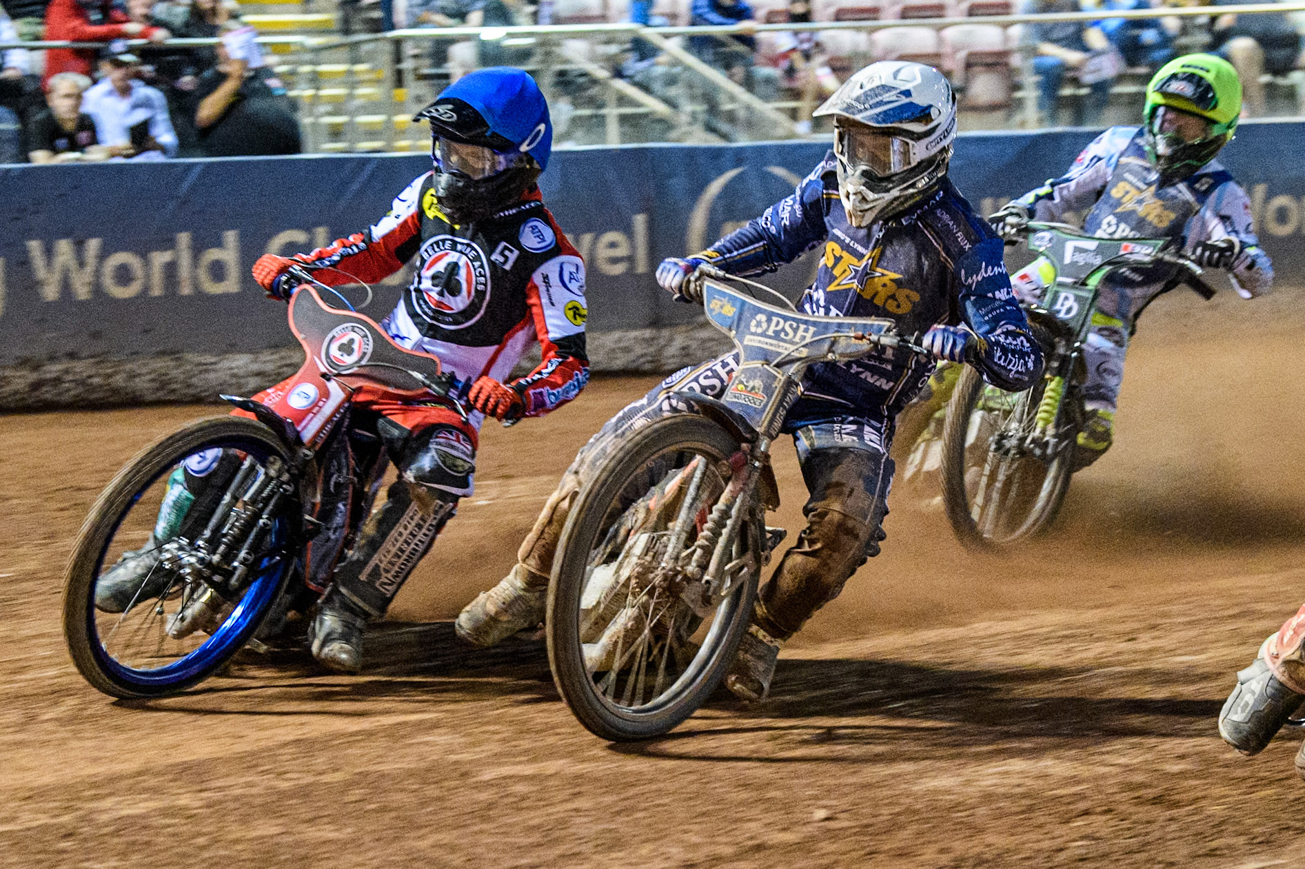 Belle Vue Aces' Brady Kurtz  in Blue rides outside Kings Lynn Stars' Jan Kvech in White with Kings Lynn Stars' Guest Rider Charles Wright  in Yellow behind during the Rowe Motor Oil Premiership match between Belle Vue Aces and King's Lynn Stars at the National Speedway Stadium, Manchester on Monday 12th August 2024. (Photo: Ian Charles | MI News)