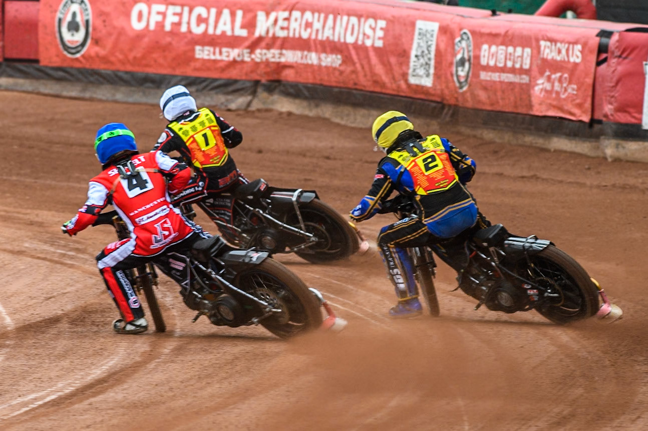 Belle Vue Colts' Jack Shimelt in Blue rides inside Leicester Lion Cubs' Eli Meadows  in Yellow and Leicester Lion Cubs' Guest Rider Ben Morley in White during the WSRA National Development League match between Belle Vue Colts and Leicester Lion Cubs at the National Speedway Stadium, Manchester on Friday 18th April 2025. (Photo: Ian Charles | MI News)