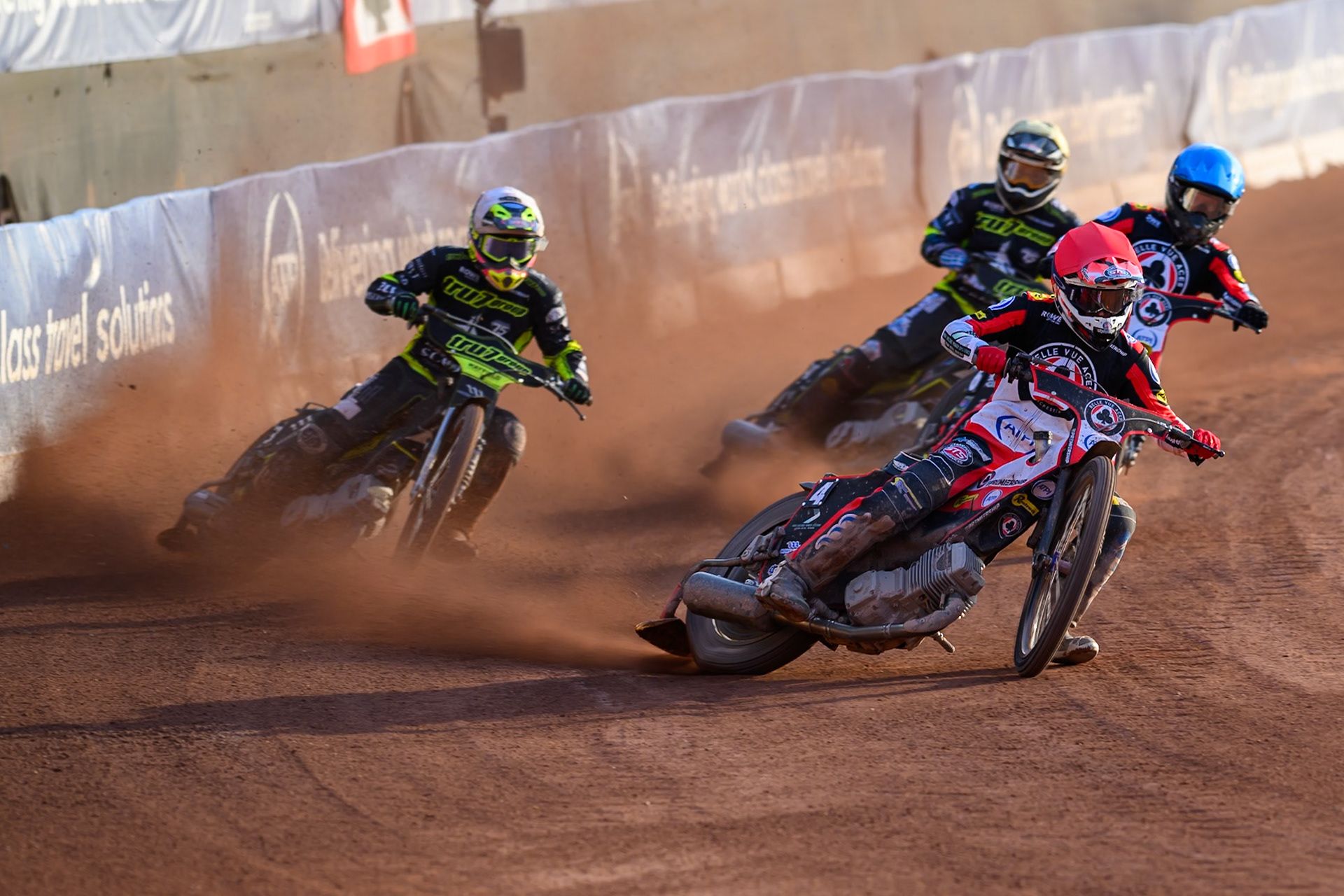 Zach Cook of Belle Vue Aces in Red and Tate Zischke of Belle Vue Aces in Blue leading Richard Lawson of Ipswich Witches in White and Scott Nichols of Ipswich Witches in Yellow during the Rowe Motor Oil Premiership match between Belle Vue Aces and Ipswich Witches at the National Speedway Stadium, Manchester on Saturday 20th June 2026. (Photo: Ian Charles | MI News)