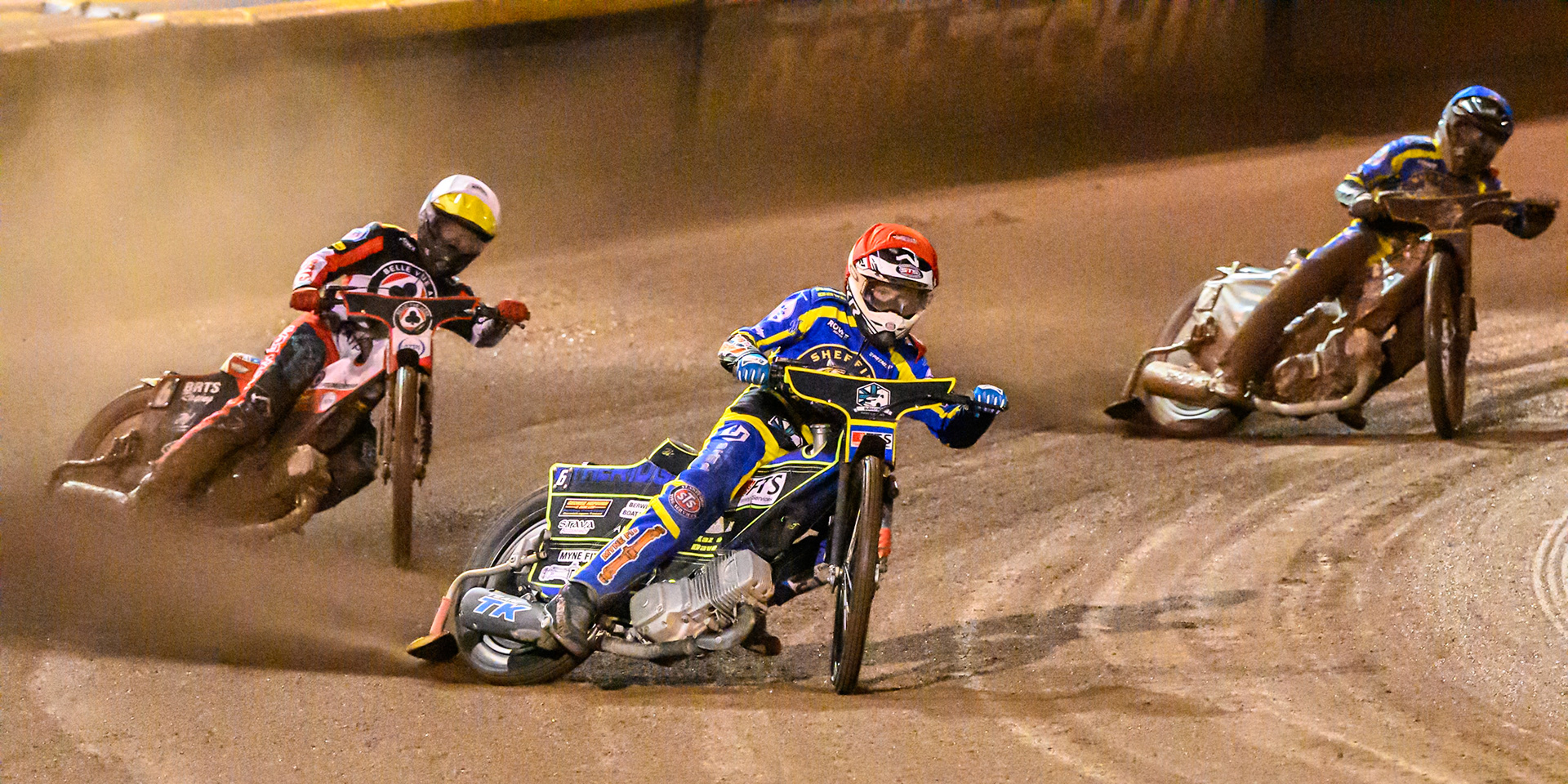 Jye Etheridge of Sheffield Tigers in Red leading Tate Zischke of Belle Vue Aces in White  and Luke Killeen of Sheffield Tigers in Blue  during the Rowe Motor Oil Premiership Grand Final 1st Leg match between Sheffield Tigers and Belle Vue Aces at Owlerton Stadium, Sheffield on Monday 12th October 2026. (Photo: Ian Charles | MI News)