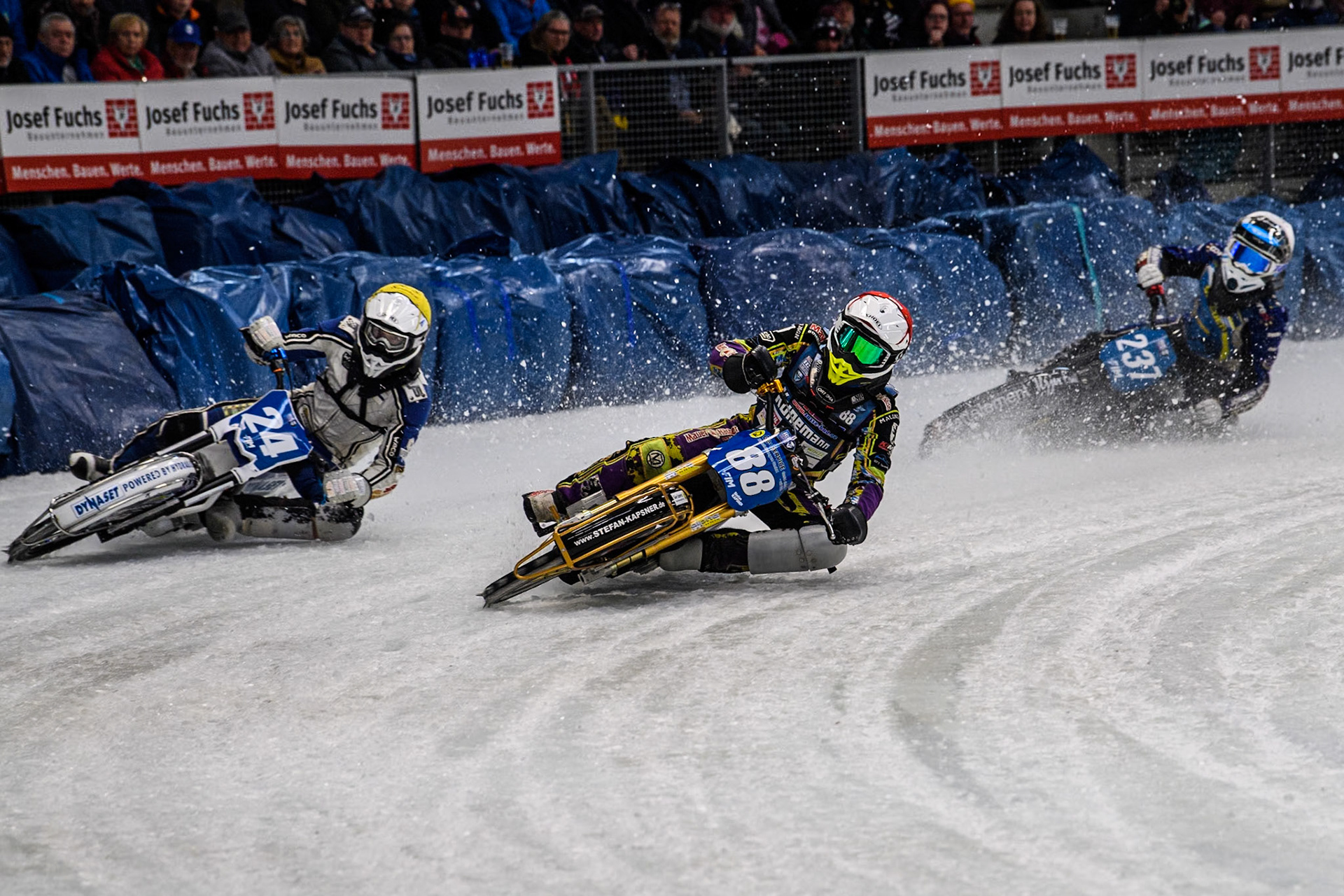 Germany's Max Niedermaier (88) (Red) inside Finland's Max Koivula (24)  (Yellow) with Sweden's Jimmy Hörnell Lidfalk (237) (White) behind during the FIM Ice Speedway Gladiators World Championship Final 2 at the Max-Aicher-Arena, Inzell on Sunday 24 March 2024. (Photo: Ian Charles | MI News)