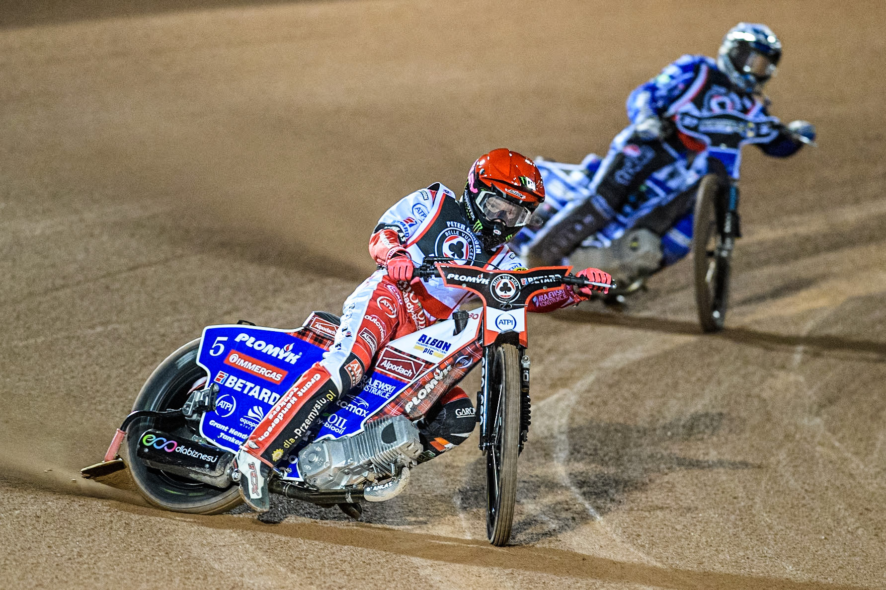 England's Dan Bewley (Red) leads  England's Chris Harris (White) during the Peter Craven Memorial Trophy meeting at the National Speedway Stadium, Manchester on Monday 18th March 2024. (Photo: Ian Charles | MI News)