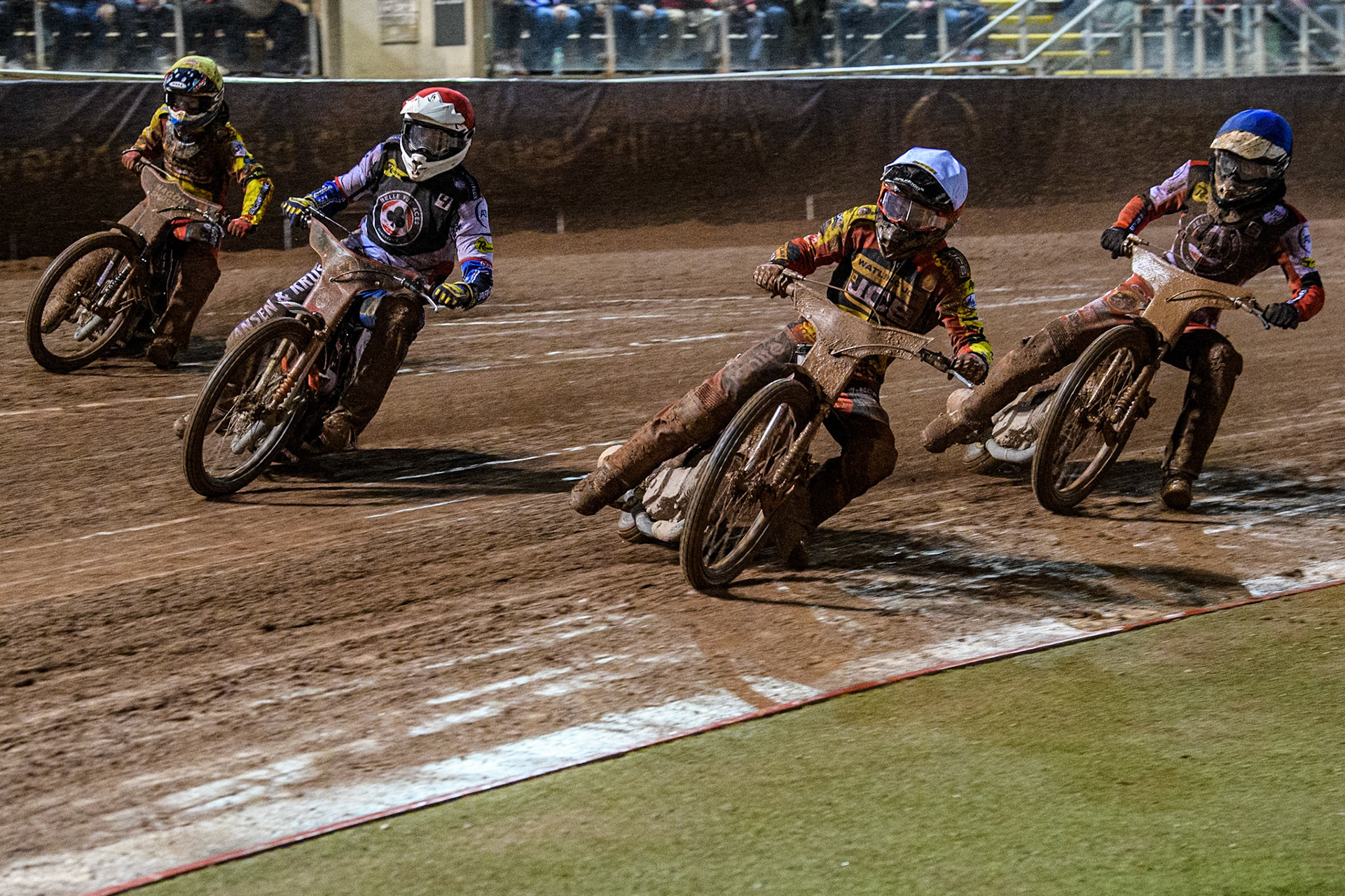 Leicester Lions' Luke Becker  in White rides inside Belle Vue Aces' Guest Rider Niels. K. Iversen  in Red with Belle Vue Aces' Antti Vuolas  in Blue and Leicester Lions' Sam Hagon in Yellow behind during the Rowe Motor Oil Premiership Grand Final 1st Leg between Belle Vue Aces and Leicester Lions at the National Speedway Stadium, Manchester on Monday 23rd September 2024. (Photo: Ian Charles | MI News)