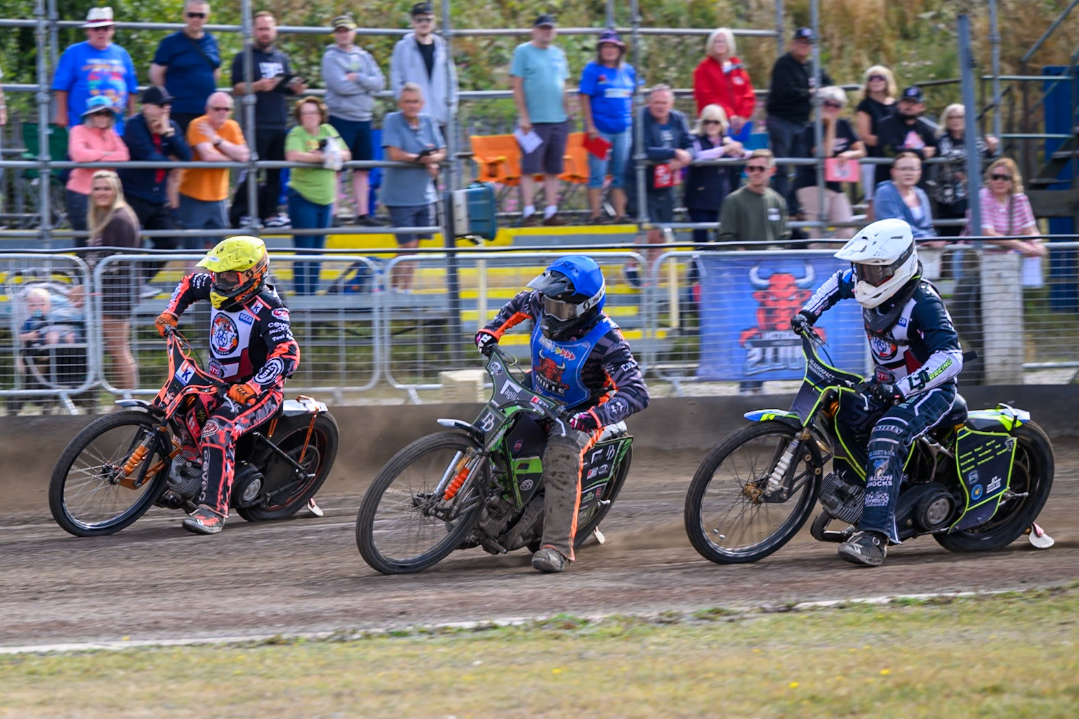 Jack Roberts of Buxton Bulls in Blue on the inside of Alex Spooner of Middlesborough Tigers in Yellow  with Nathan Ablitt of Middlesborough Tigers in White behind during the WSRA National Development League match  between Buxton Bulls and Middlesborough Tigers at Hi-Edge Speedway, Buxton on Sunday 16th August 2026. (Photo: Ian Charles | MI News)