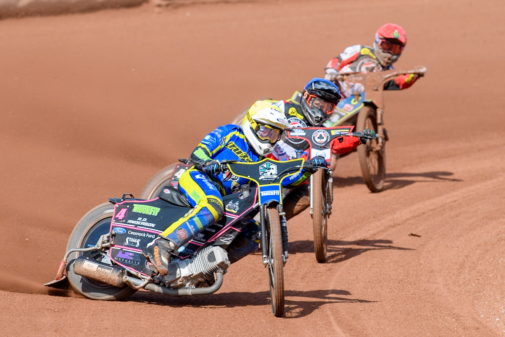 Sheffield Tigers' Josh Pickering  in Yellow leading Belle Vue Aces' Ben Cook  in Blue and Belle Vue Aces' Jaimon Lidsey  in Red during the Rowe Motor Oil Premiership match between Belle Vue Aces and Sheffield Tigers at the National Speedway Stadium, Manchester on Monday 26th August 2024. (Photo: Ian Charles | MI News)