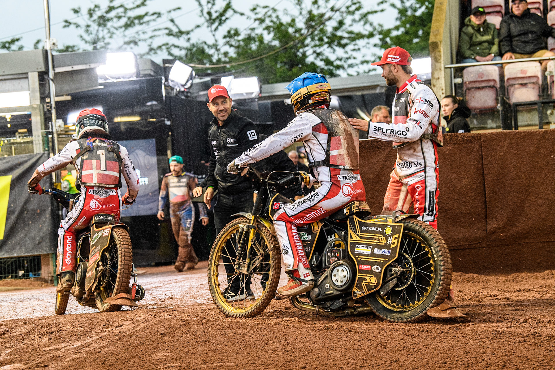 The Danes are congratulated by their team mate and manager after their meeting winning heat during the Monster Energy FIM Speedway of Nation Semi Final 2 at the National Speedway Stadium, Manchester on Wednesday 10th July 2024. (Photo: Ian Charles | MI News)